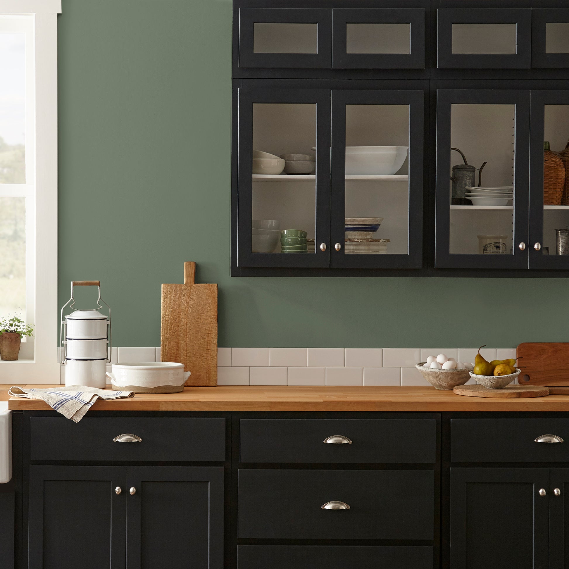 dark sage green paint named lemon leaves shown painted on kitchen wall