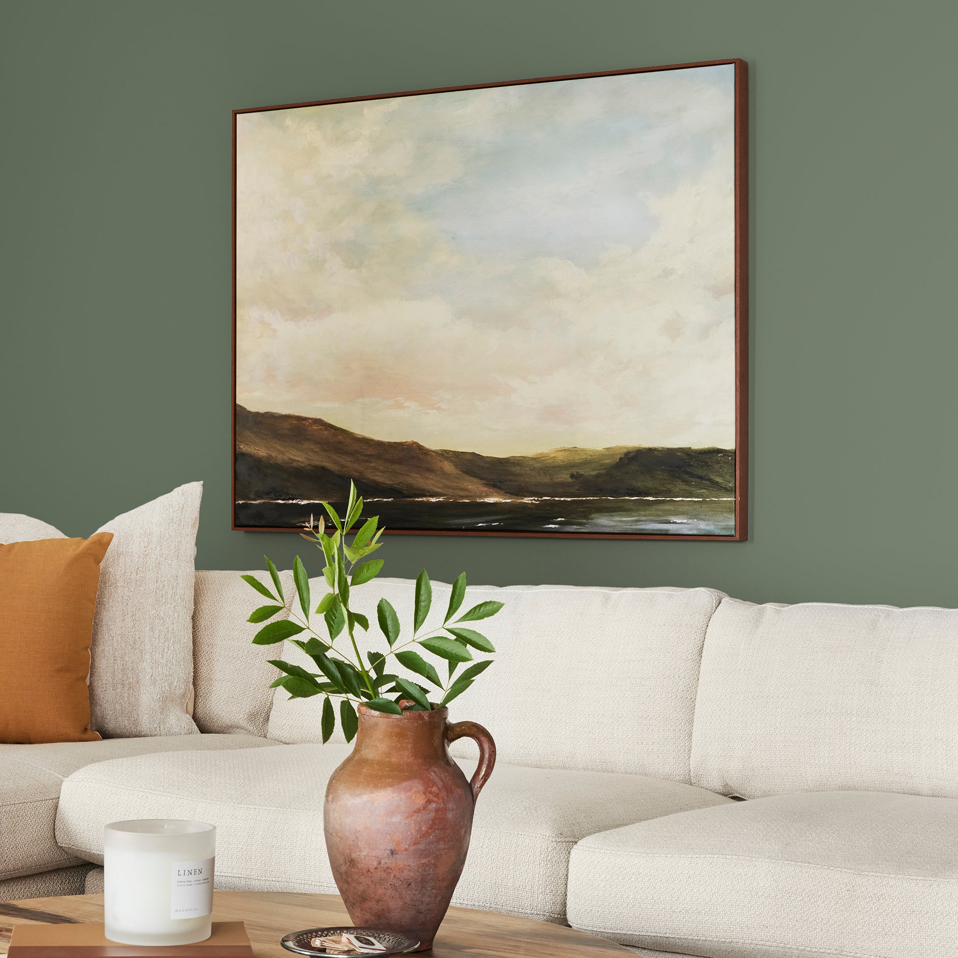 dark sage green paint named lemon leaves shown painted on living room wall