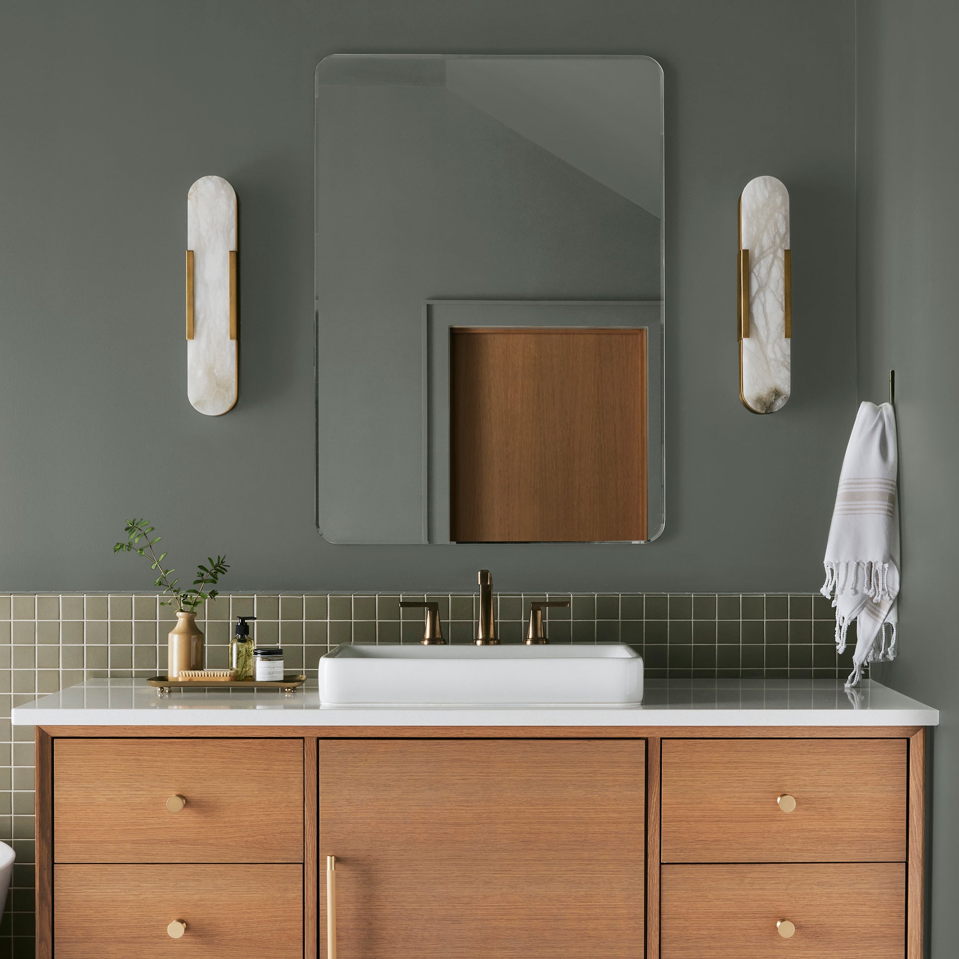 Army green with earthy brown and gray undertones interior paint named wellington green shown painted on bathroom wall