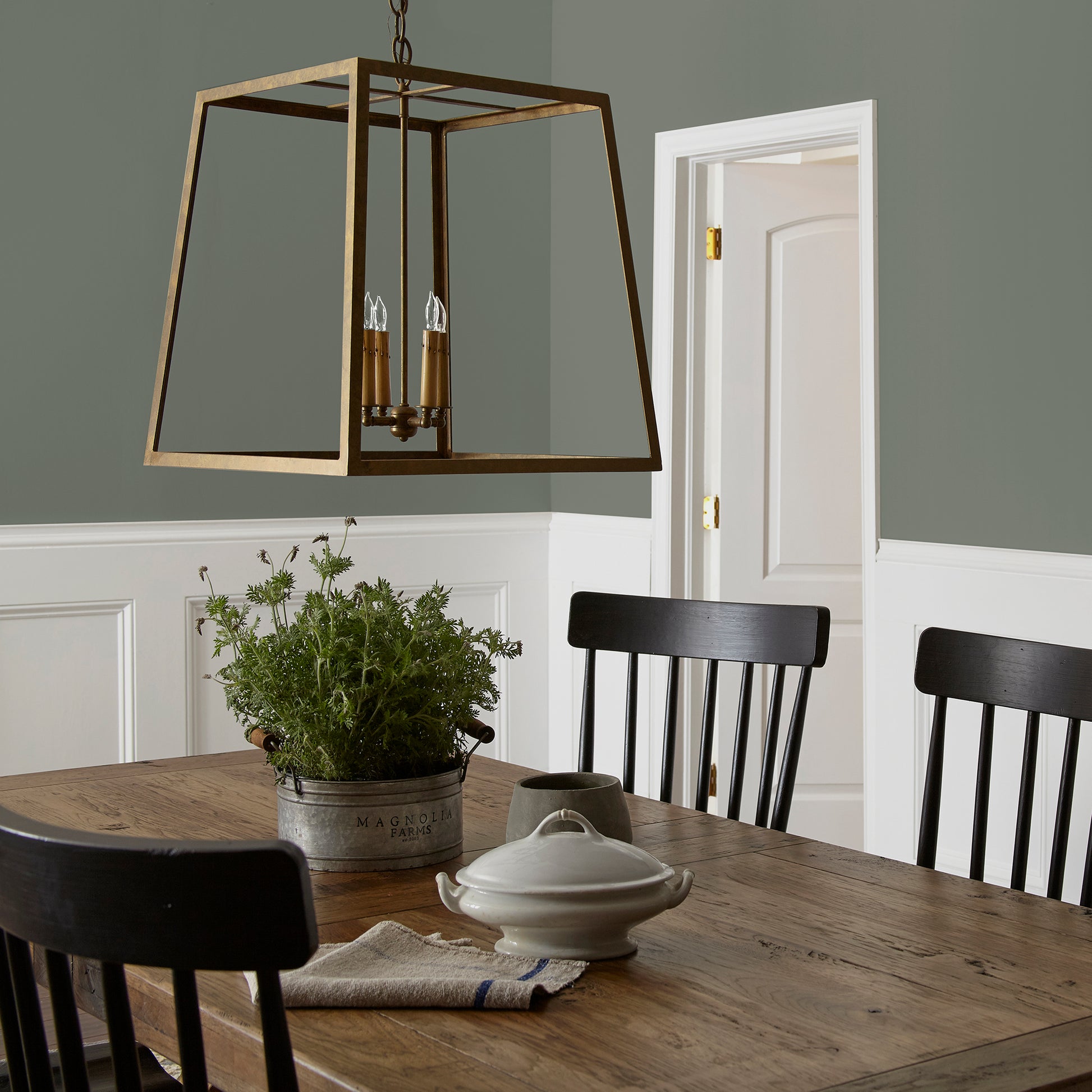 Army green with earthy brown and gray undertones interior paint named wellington green shown painted on dining room wall