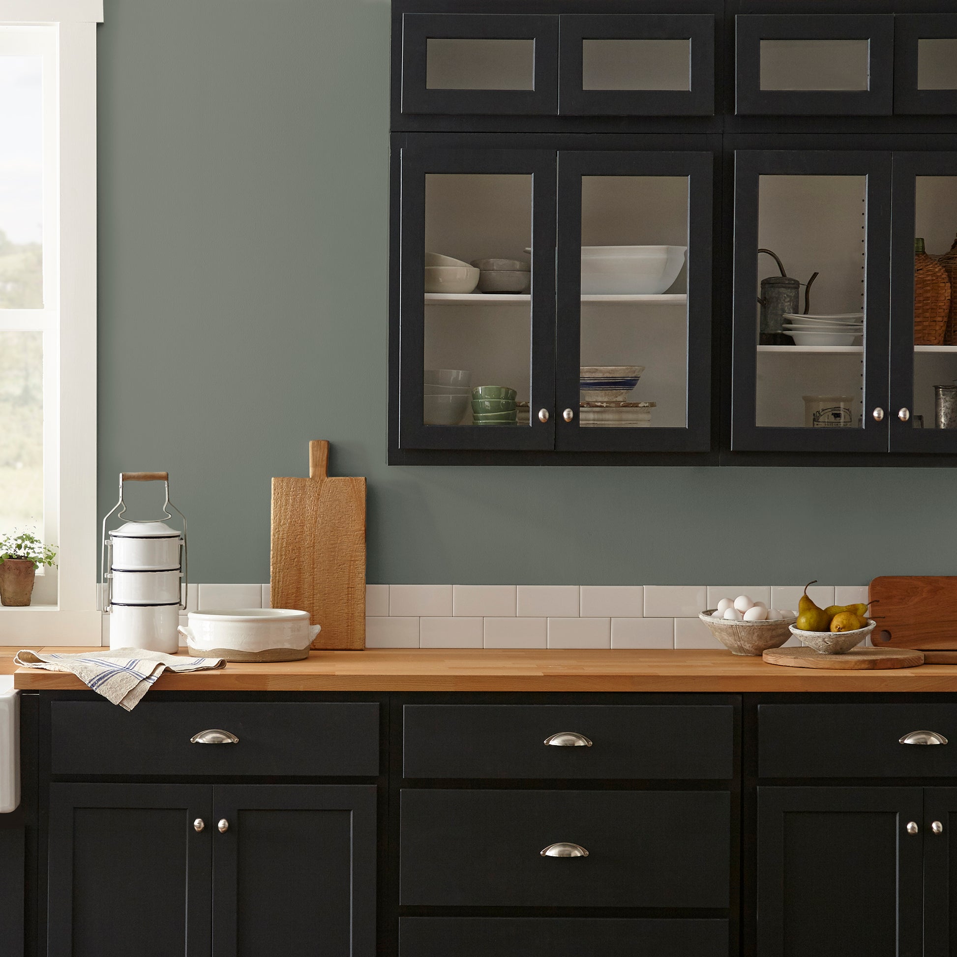 Army green with earthy brown and gray undertones interior paint named wellington green shown painted on kitchen wall