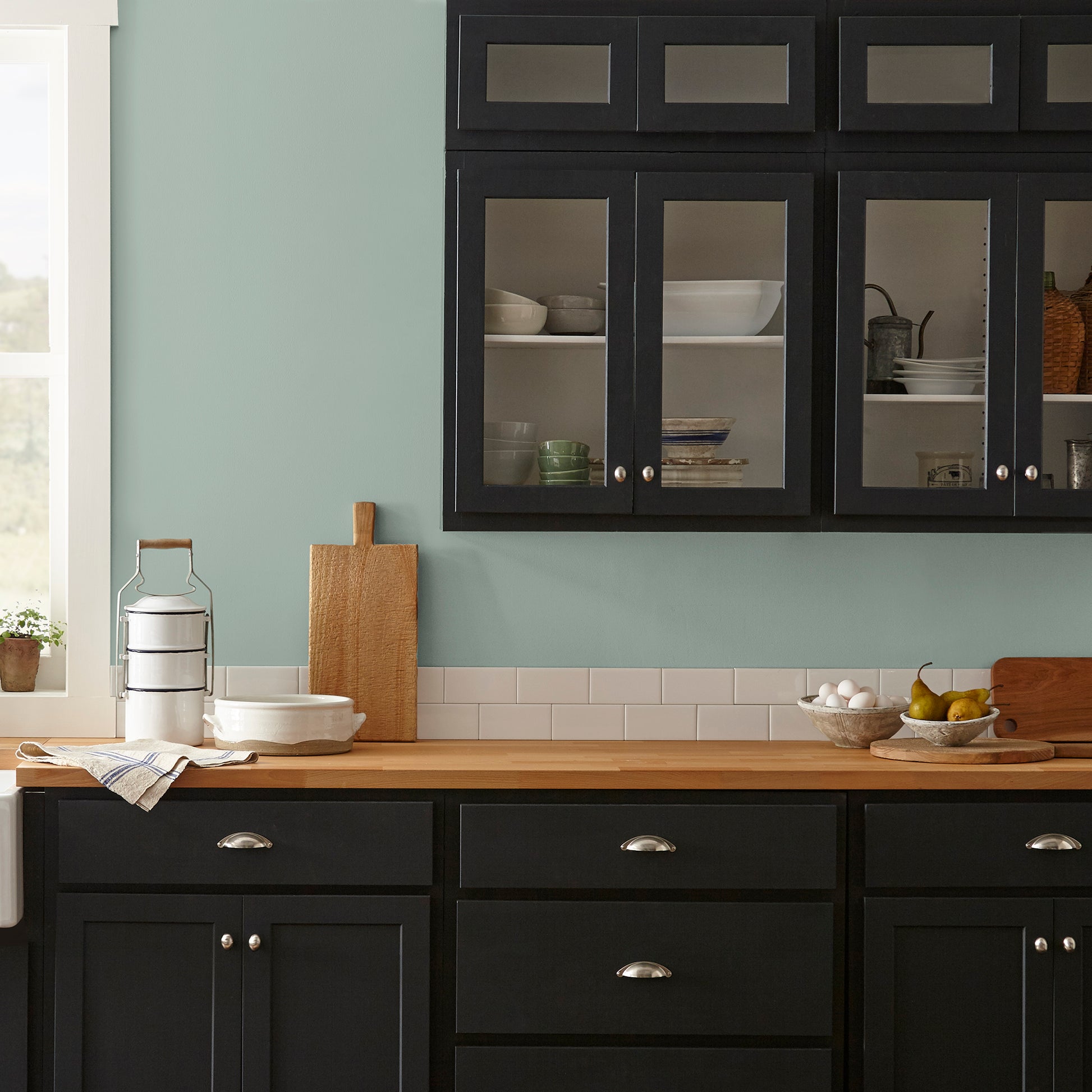 Washed mint green interior paint named local greenhouse shown painted on kitchen wall