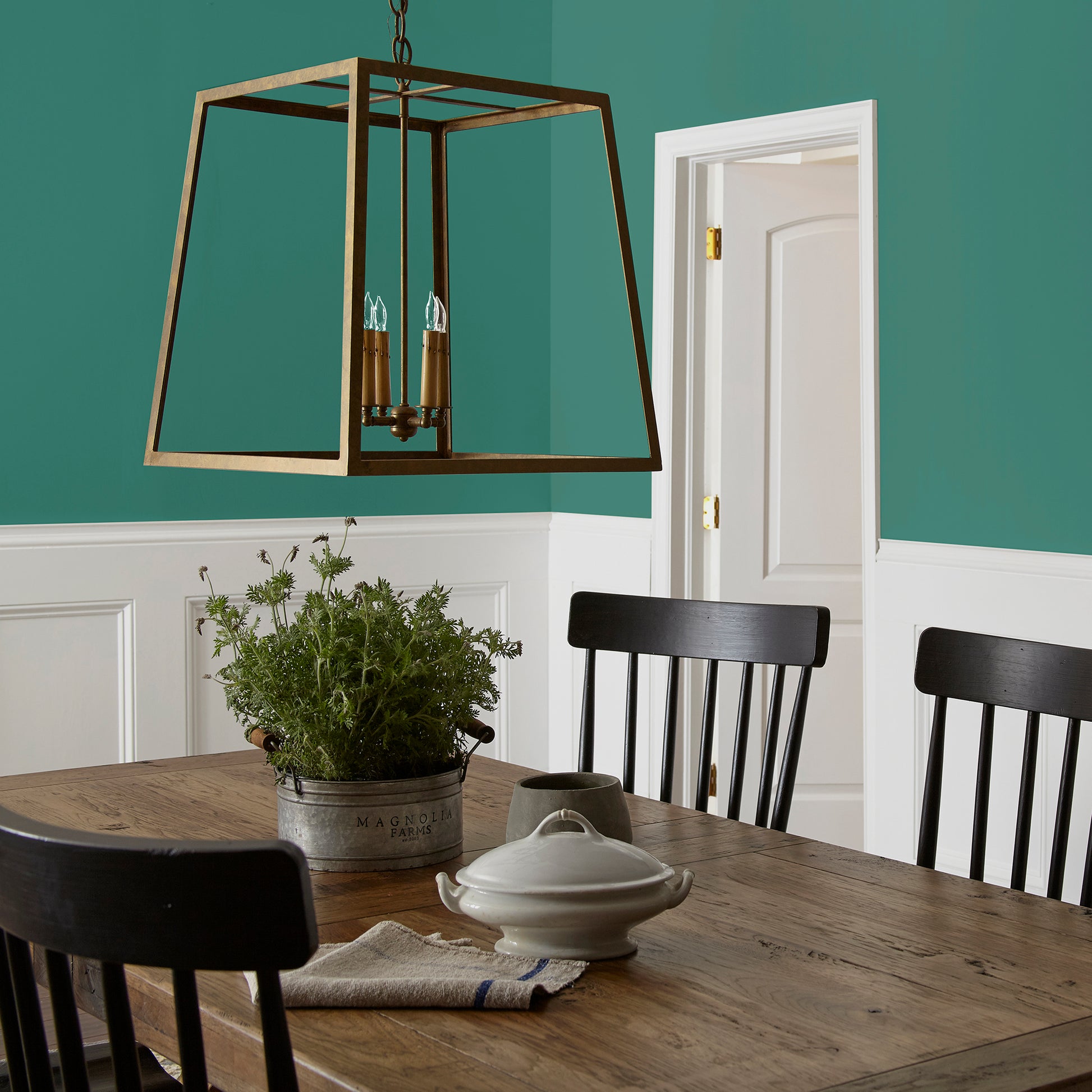 crisp hunter green with golden accents paint named aspen leaf shown painted on dining room wall