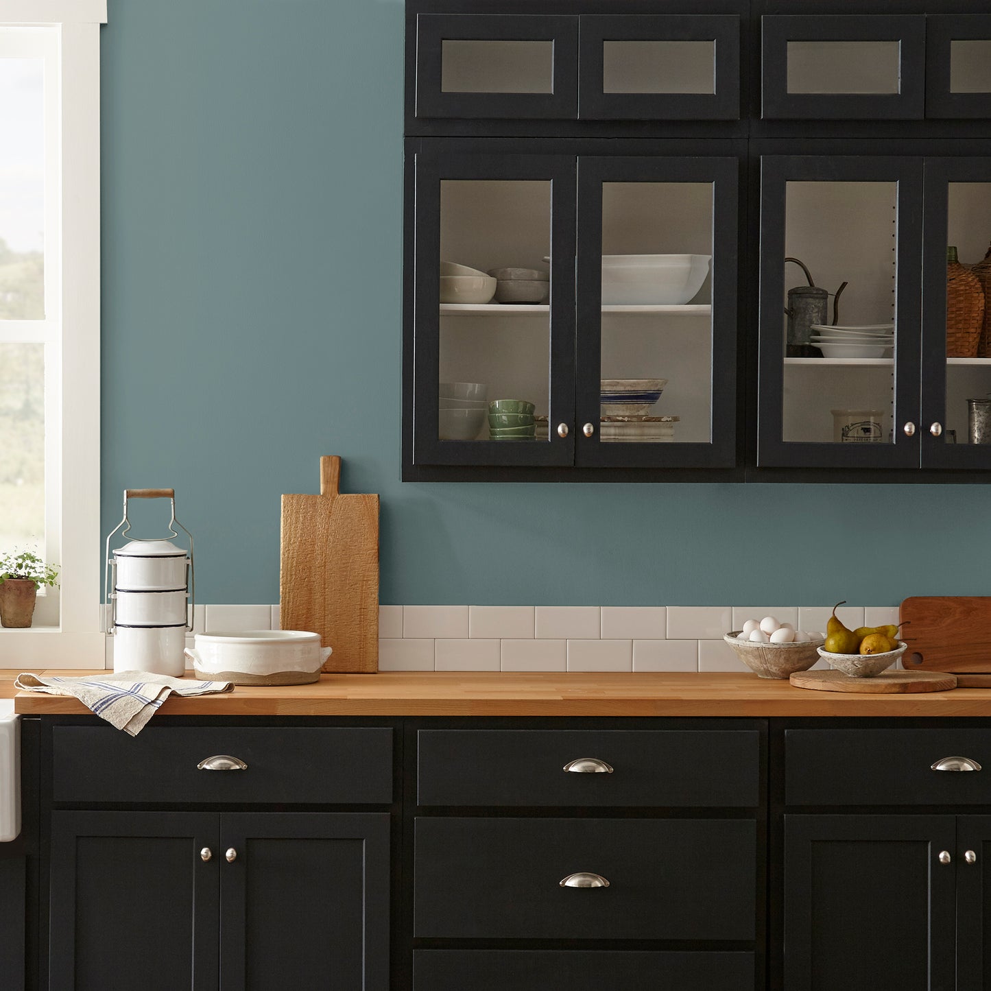Deep dusty sea green interior paint named demo day shown painted on kitchen wall