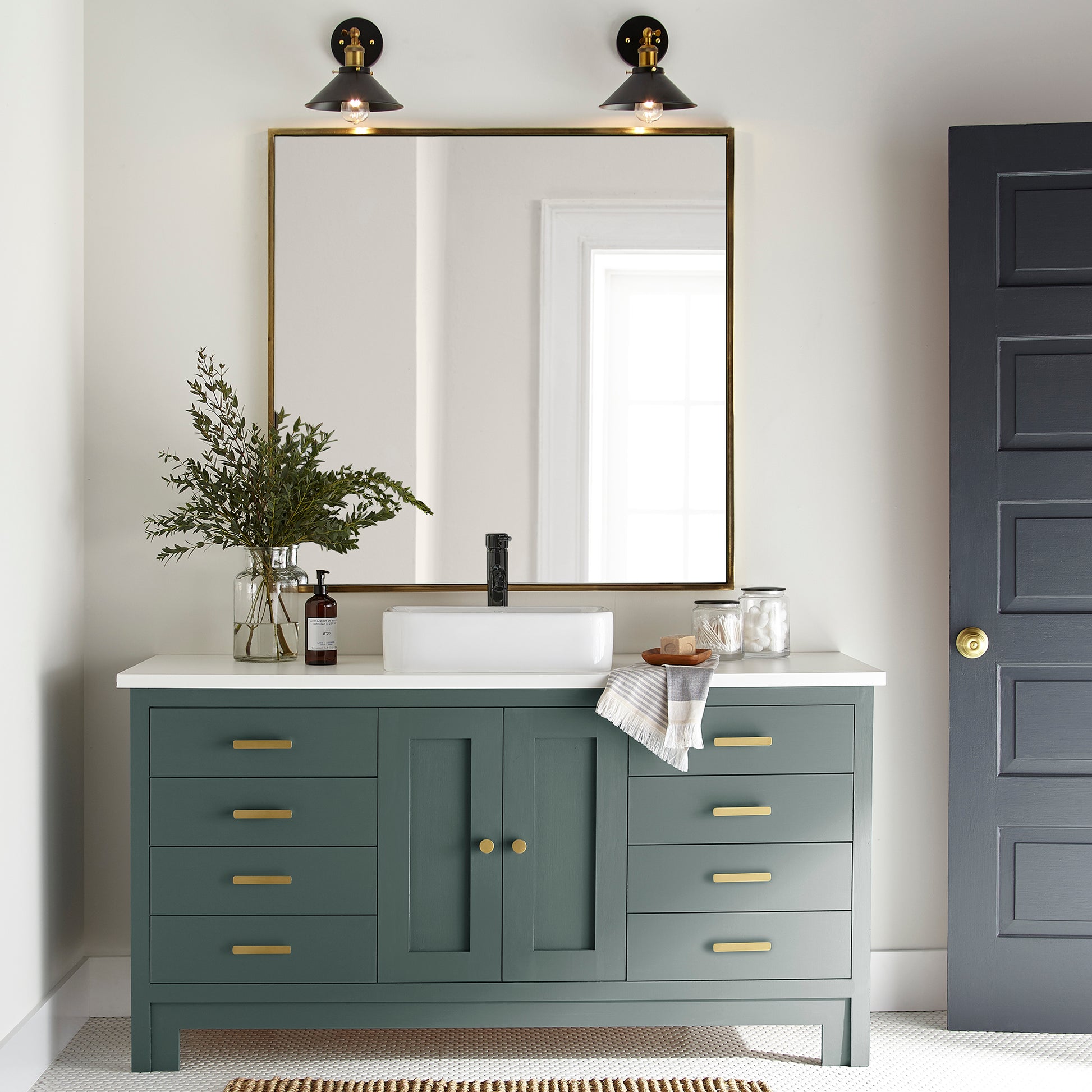 A slightly jeweled forest green hue door and cabinet paint named 1905 green shown painted on bathroom cabinet