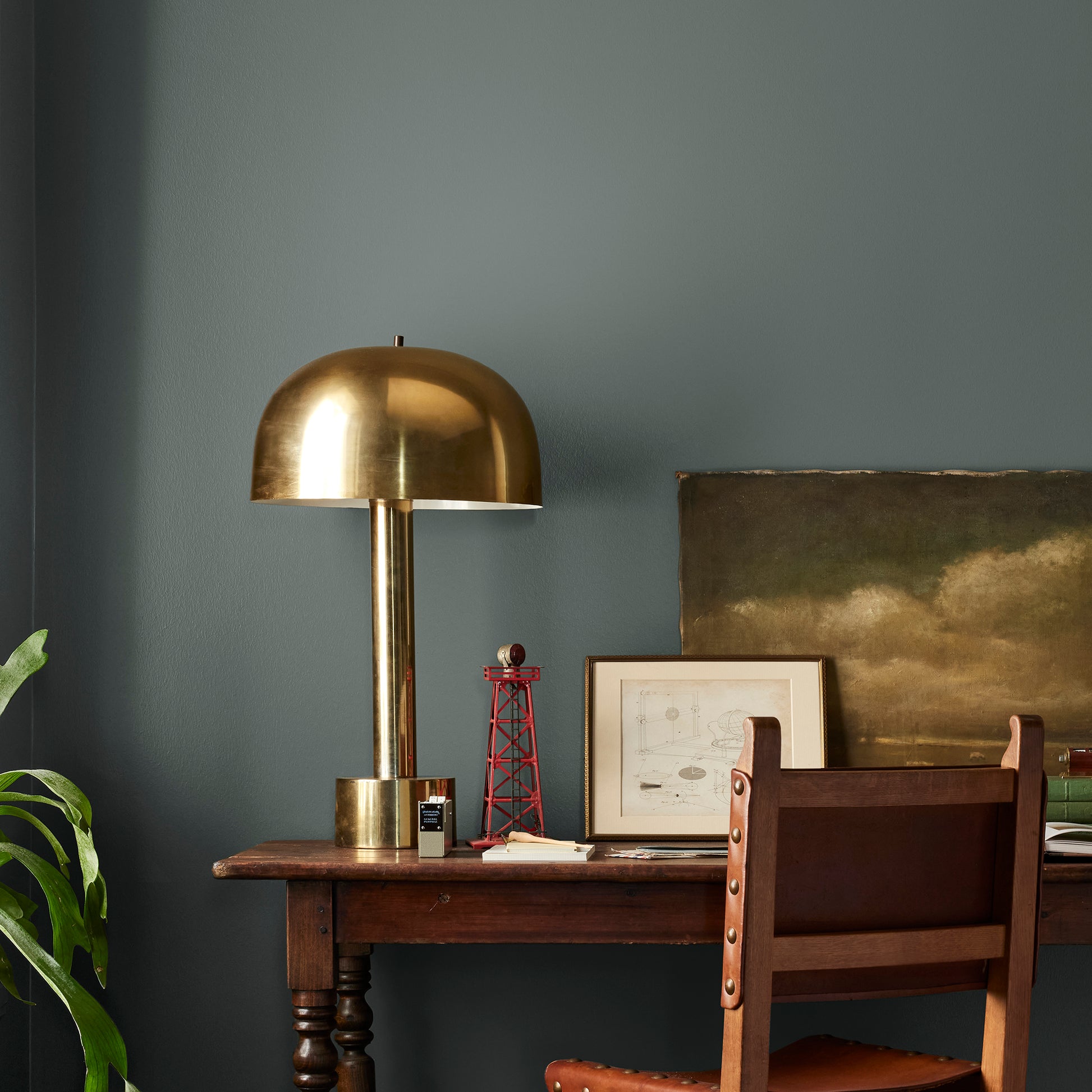 A slightly jeweled forest green hue classic interior paint named 1905 shown painted on bedroom wall