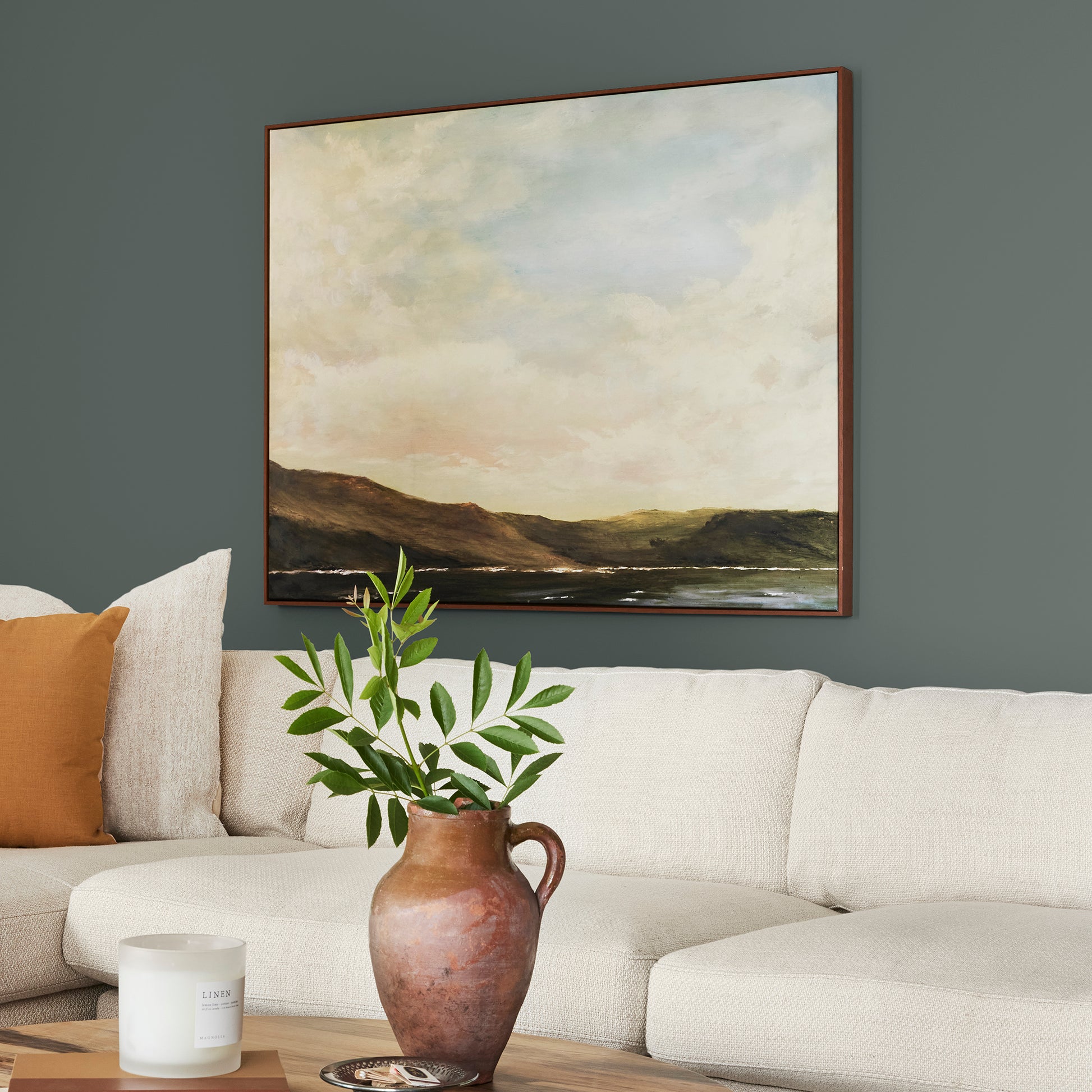 A slightly jeweled forest green hue classic interior paint named 1905 green shown painted on living room wall