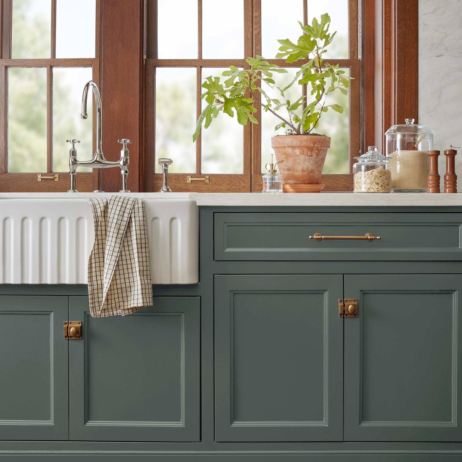 A slightly jeweled forest green hue door and cabinet paint named 1905 green shown painted on kitchen cabinet