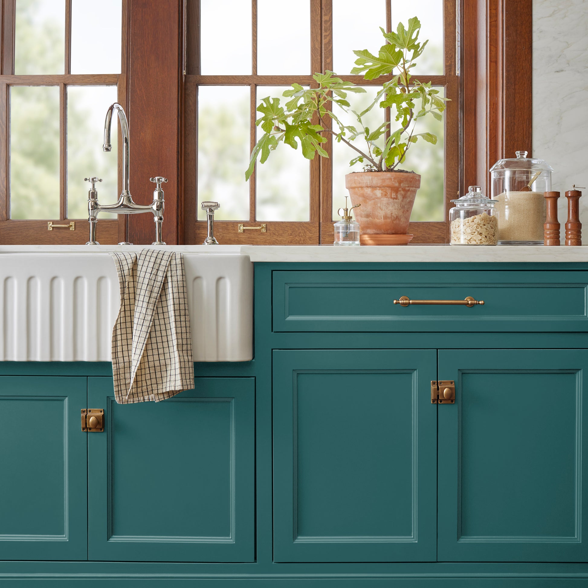 Blue and green combined to create an ashy peacock blue door and cabinet paint named water garden shown painted on kitchen cabinet