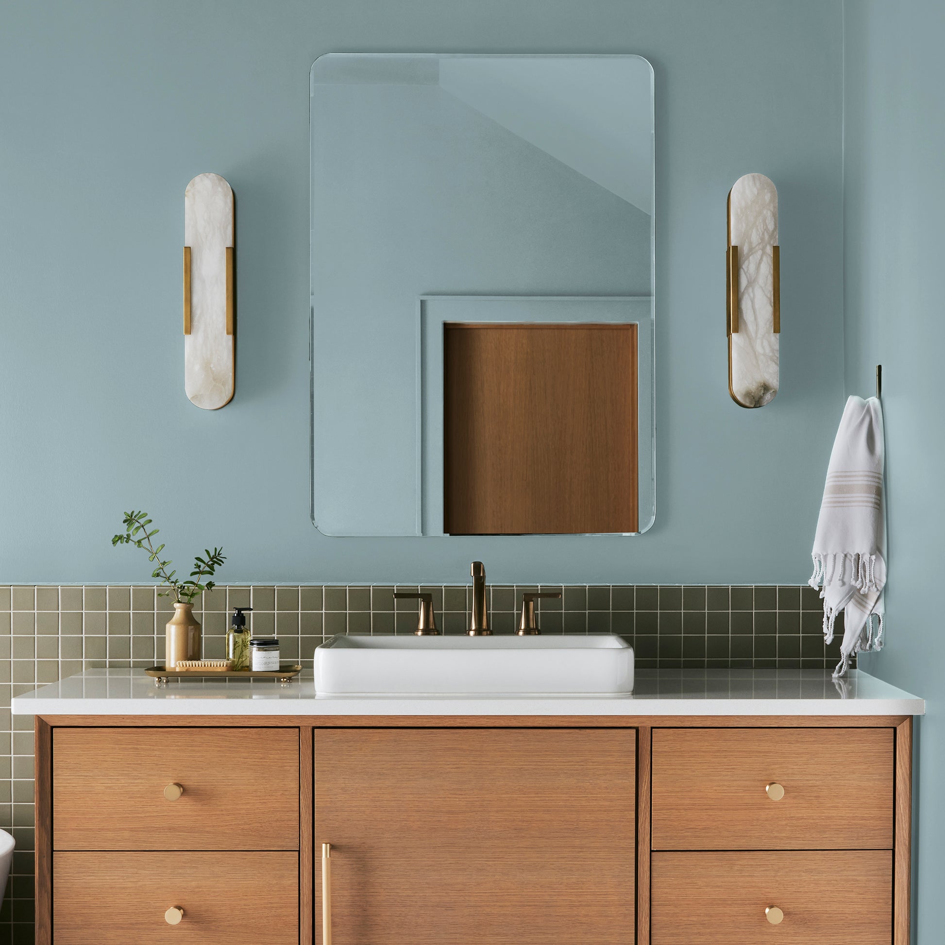 A muted blue interior paint named vibrant horizon shown painted on bathroom wall