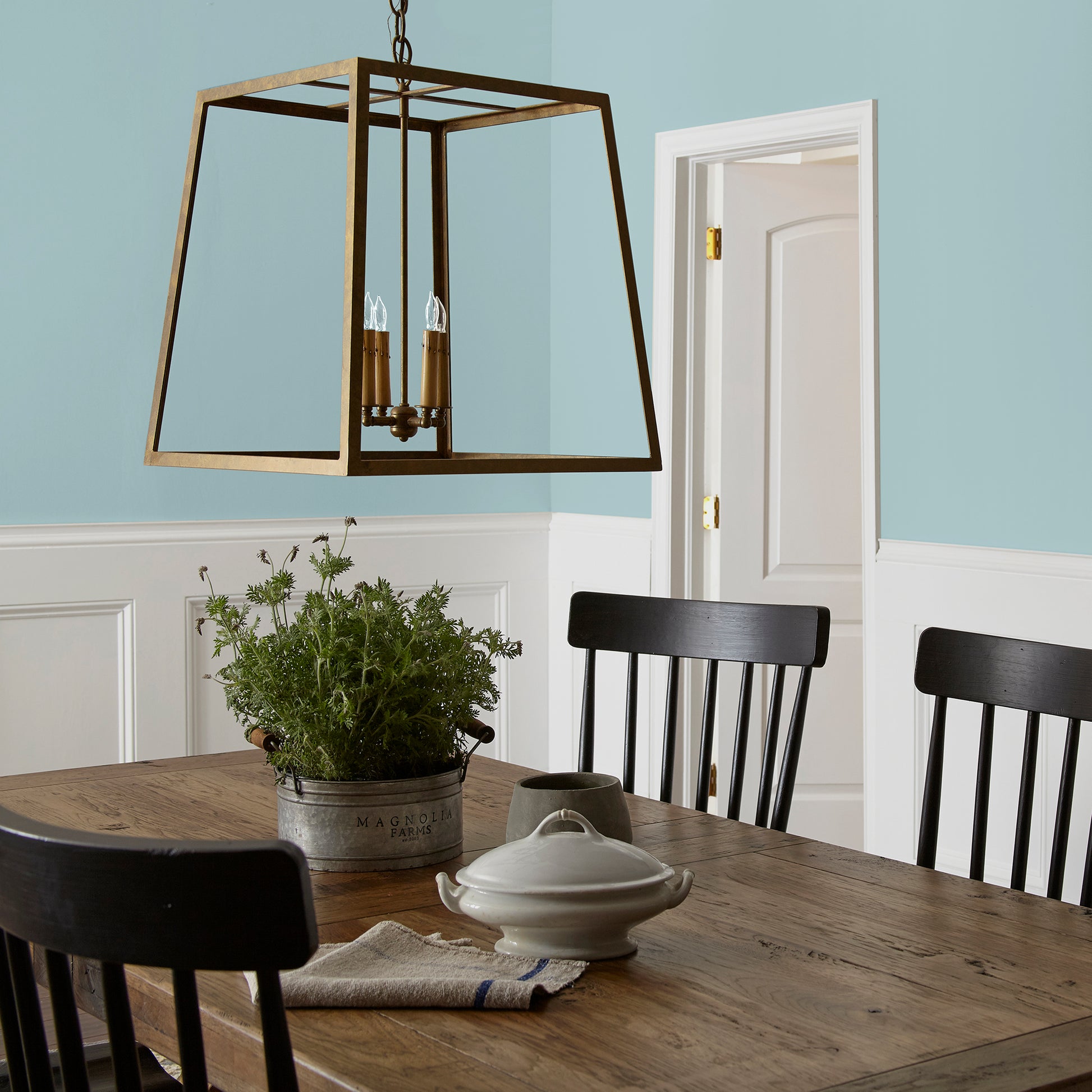A muted blue interior paint named vibrant horizon shown painted on dining room wall