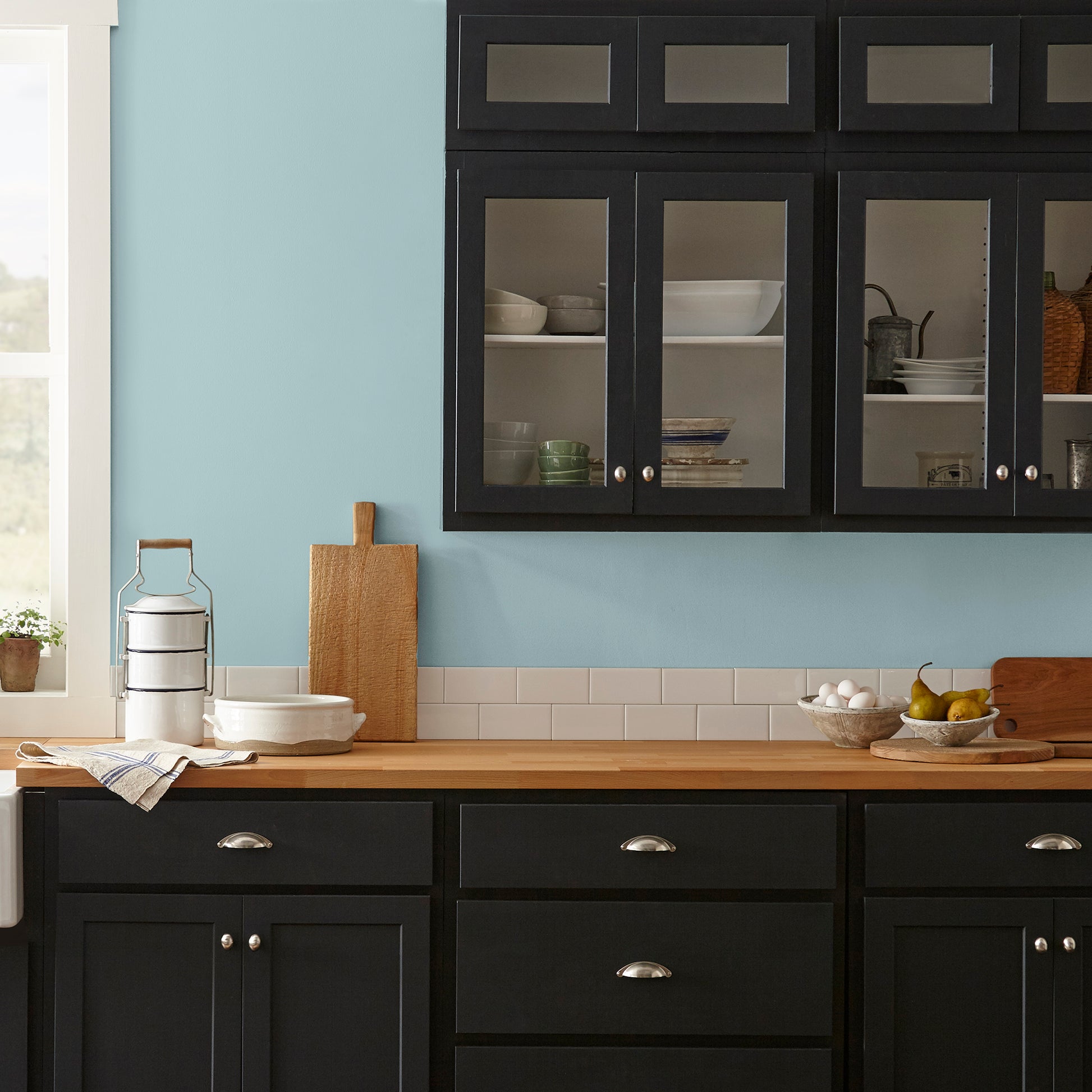 A muted blue interior paint named vibrant horizon shown painted on kitchen wall