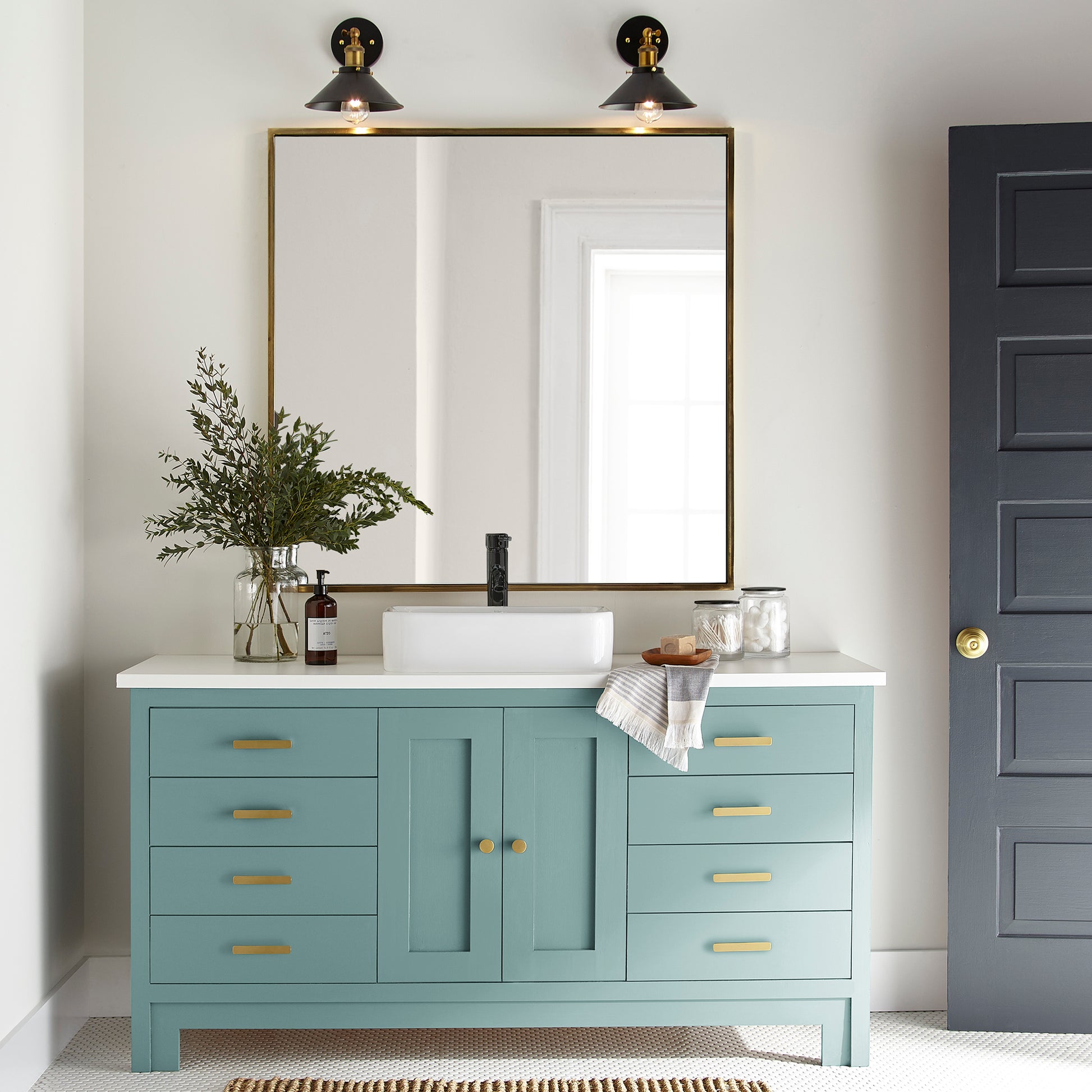 A cool aqua blue door and cabinet paint named morning calm shown painted on bathroom cabinet