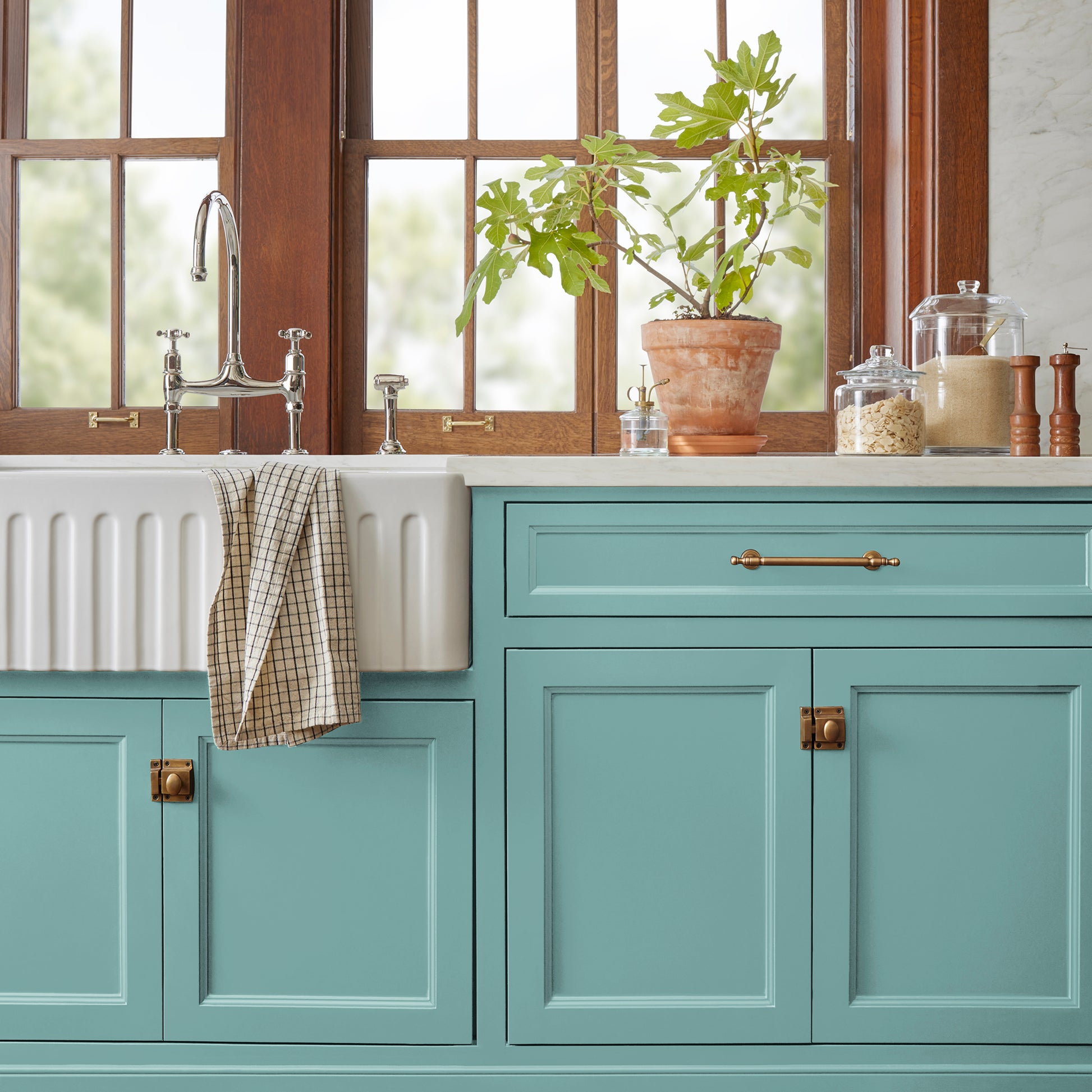 A cool aqua blue door and cabinet paint named morning calm shown painted on kitchen cabinet
