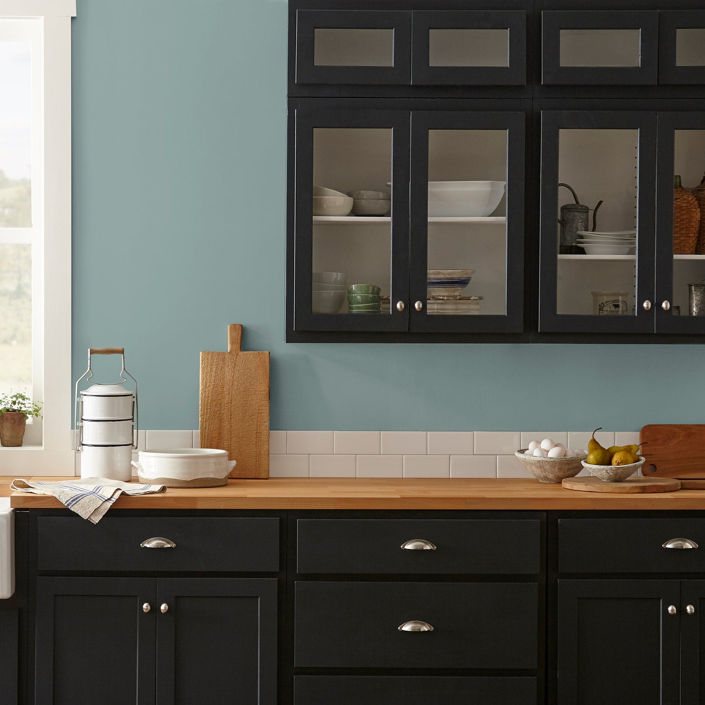 Ashy green with aqua undertone interior paint named well watered shown painted on kitchen wall