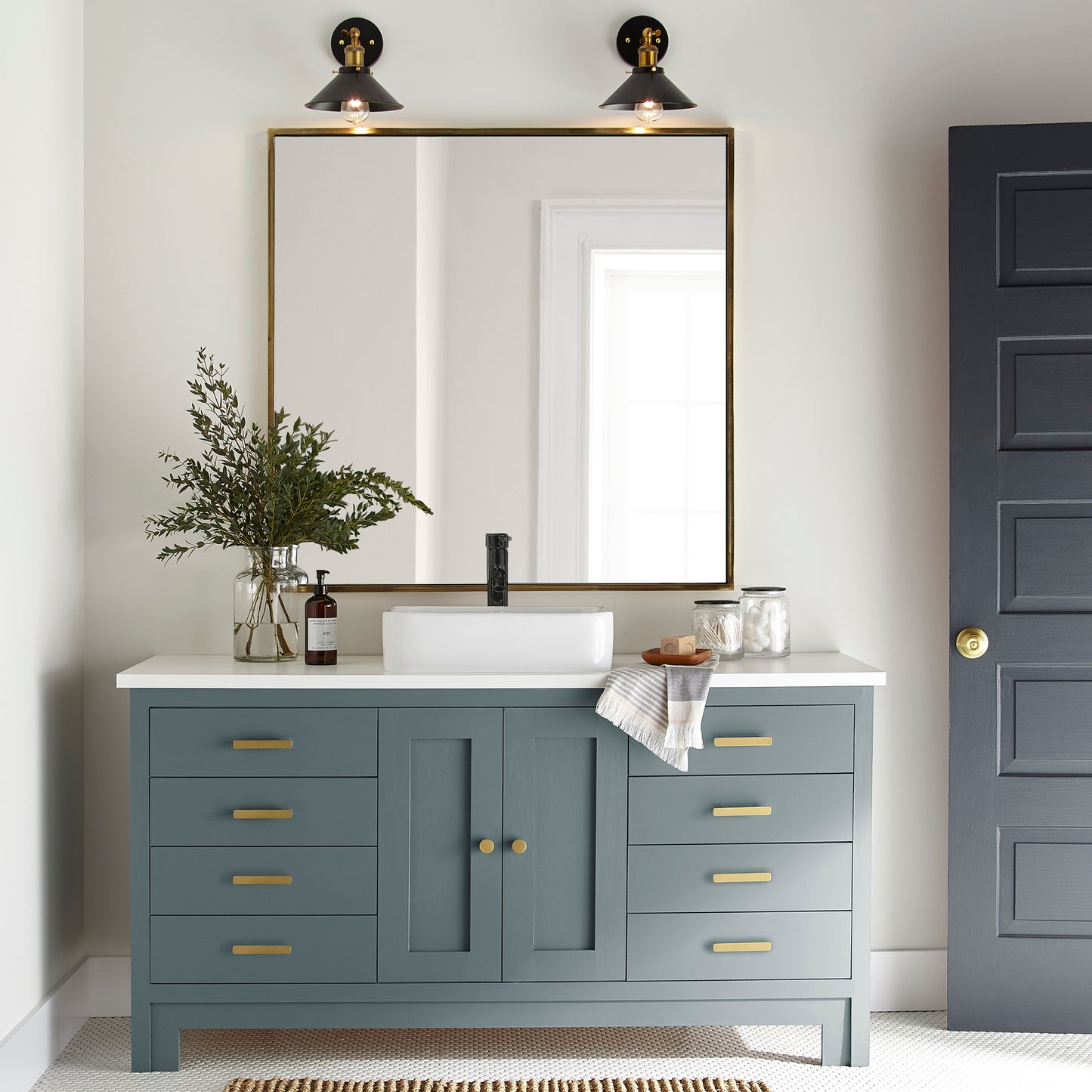 A grayed out blue door and cabinet paint named storm chaser shown painted on bathroom cabinet