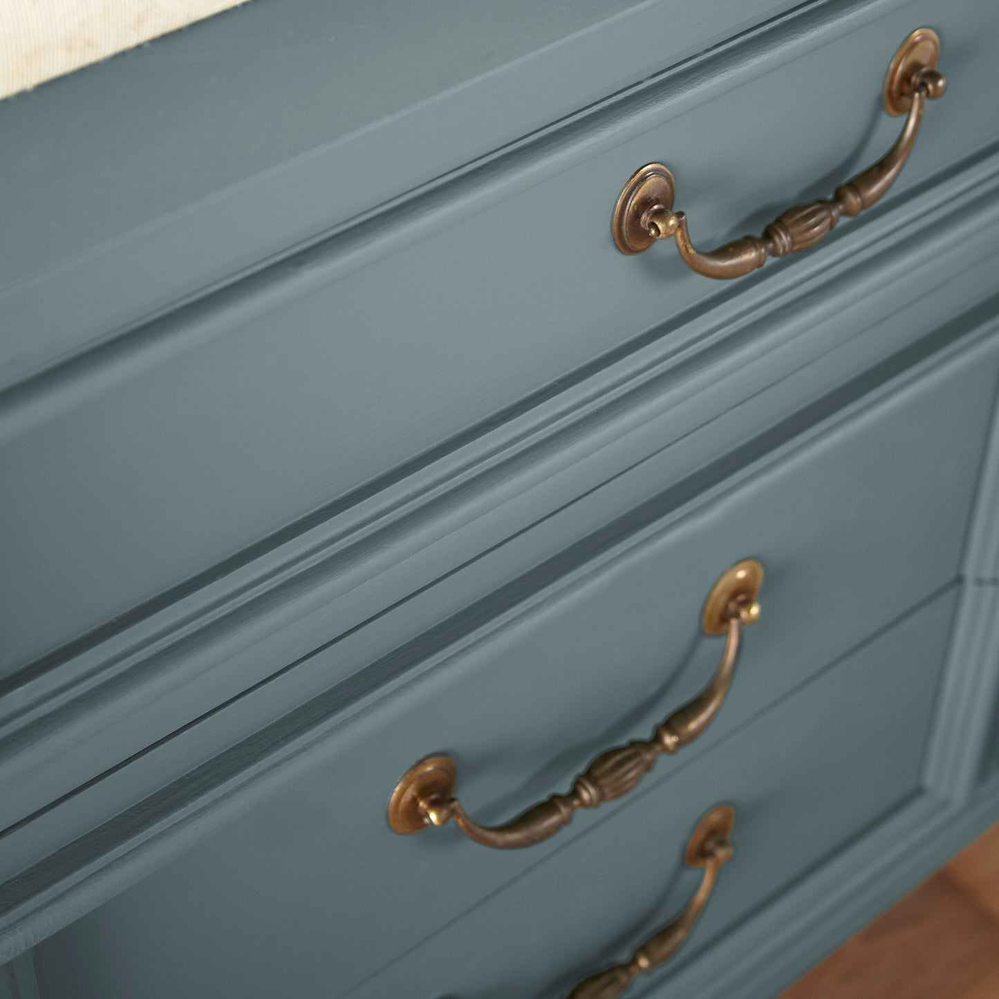 A grayed out blue door and cabinet paint named storm chaser shown painted on cabinet