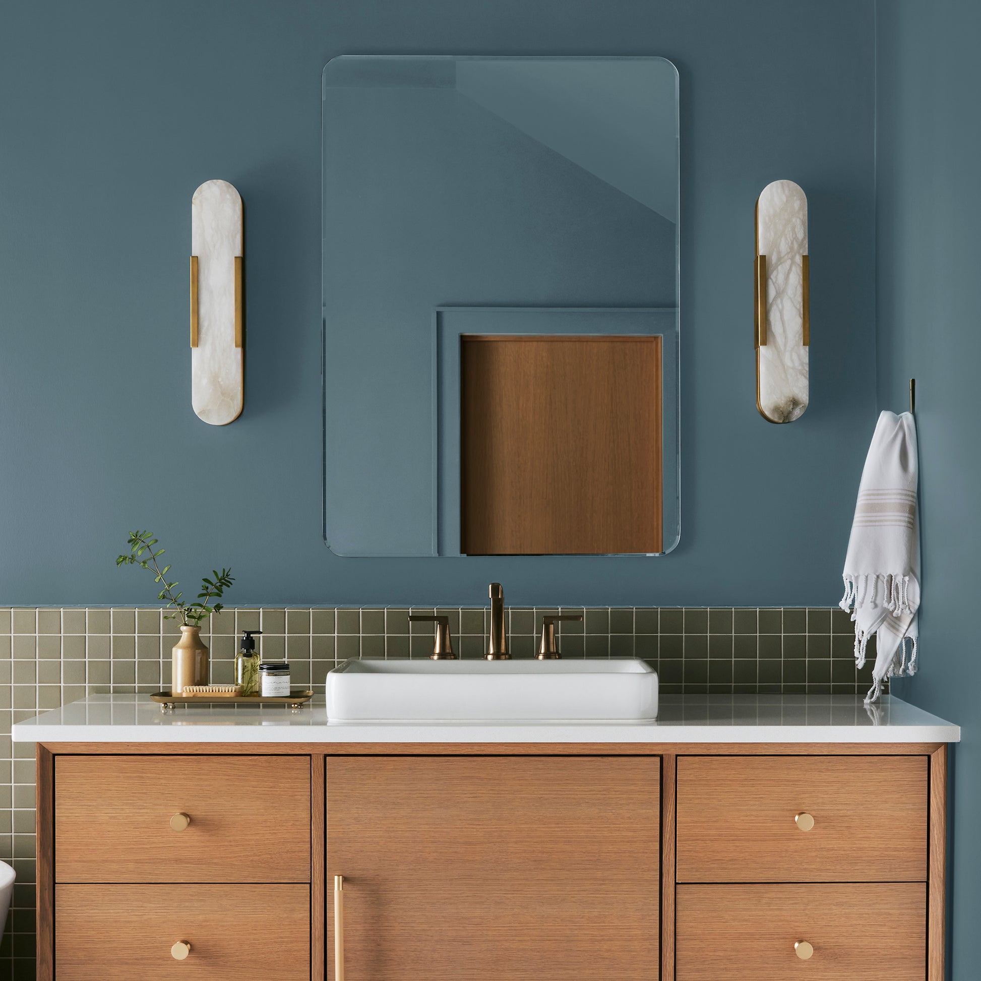 deep steel blue with grey undertone paint named blue skies shown painted on bathroom wall