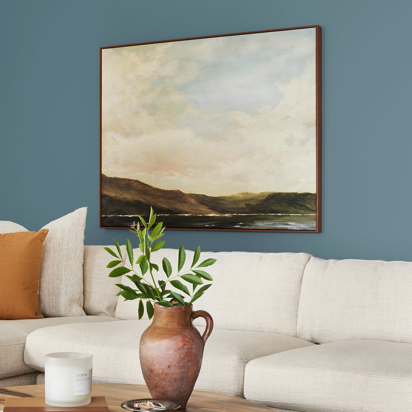 deep steel blue with grey undertone paint named blue skies shown painted on living room wall