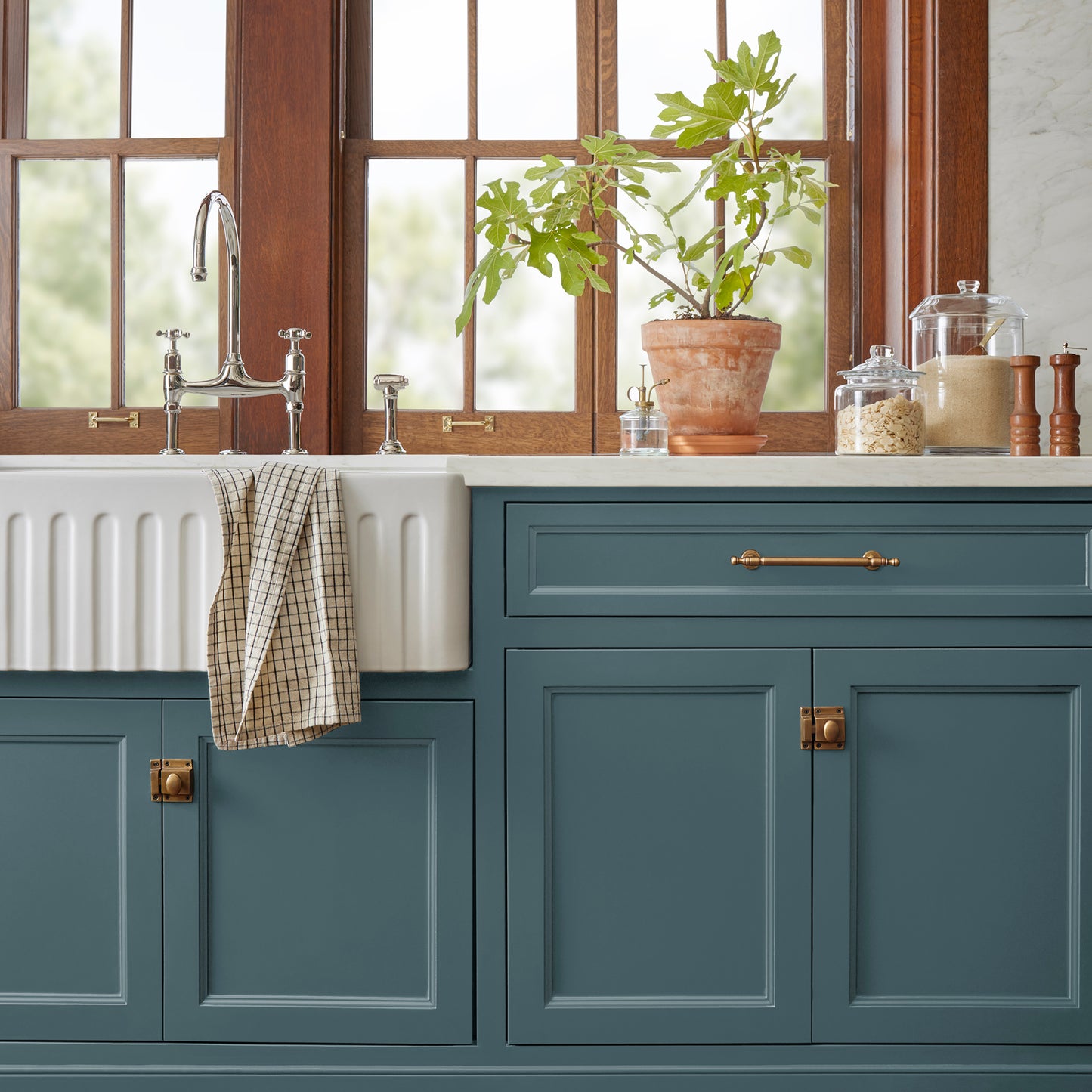 Deep sea blue with a gray caste door and cabinet paint named together shown painted on kitchen cabinet