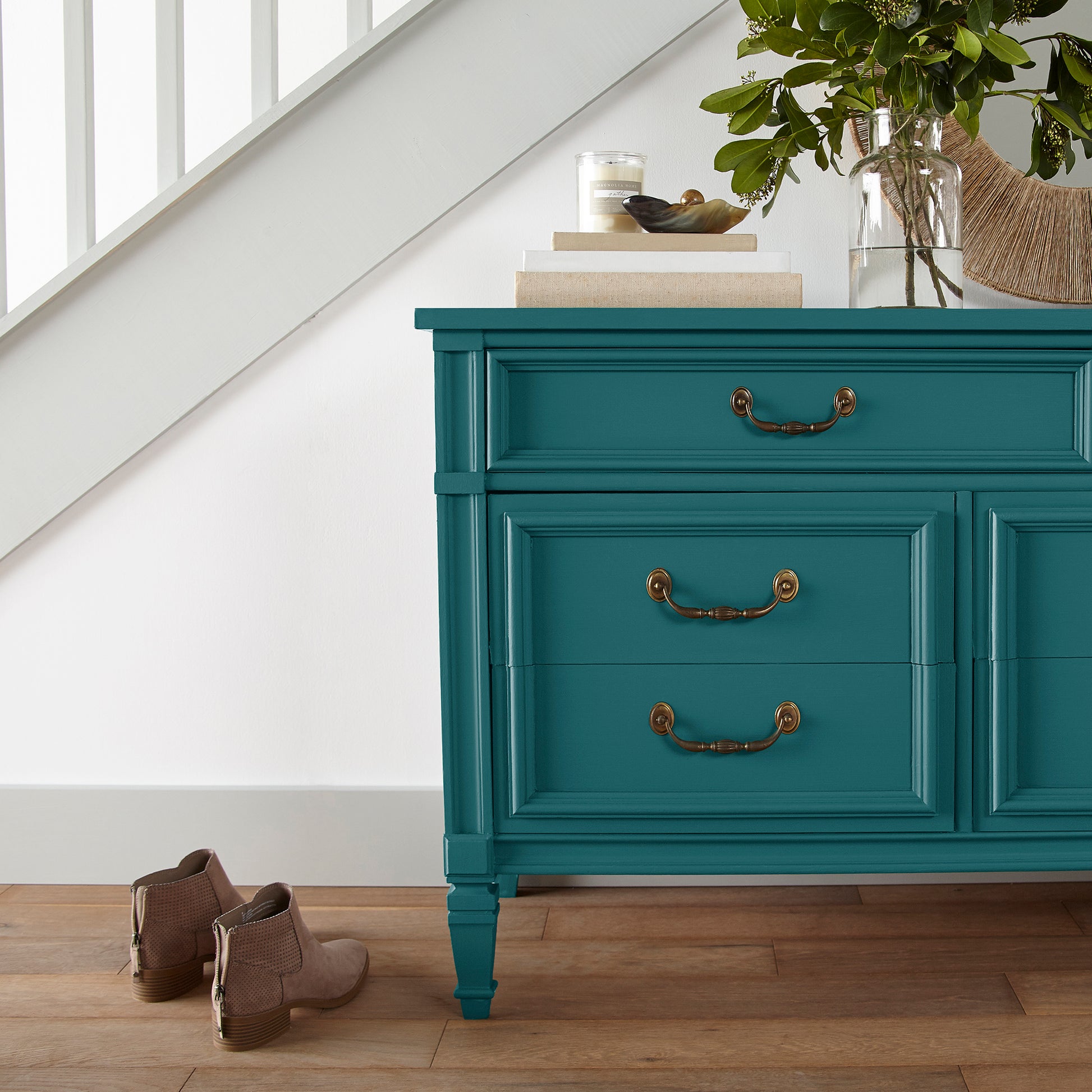 A deep peacock blue door and cabinet paint named under the stars shown painted on entryway cabinet