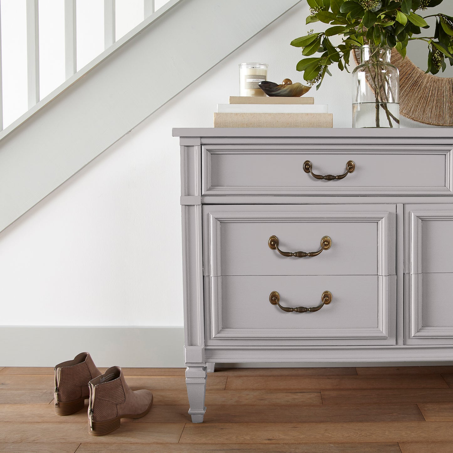 A muted lavender door and cabinet paint named in bloom shown painted on entryway cabinet