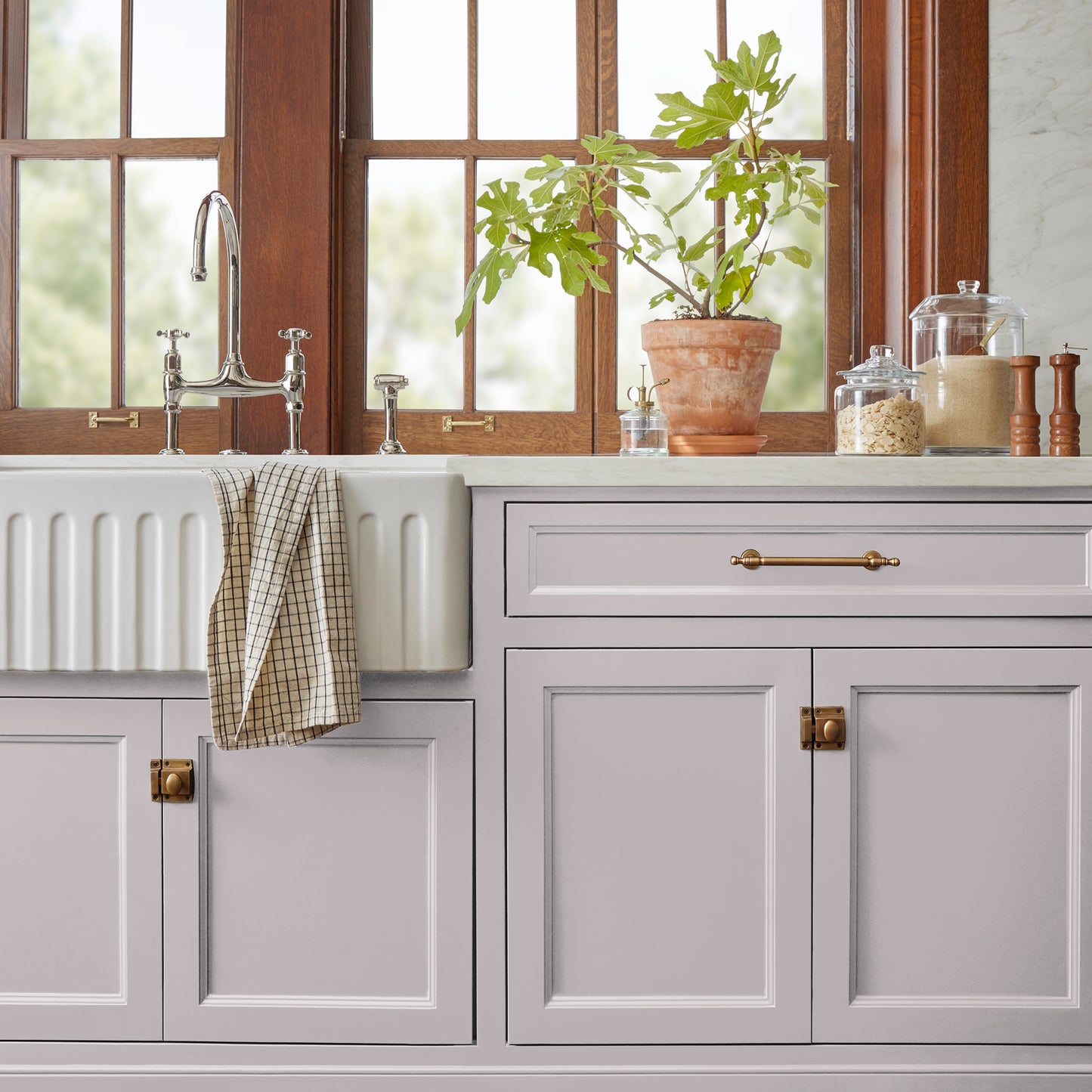 A muted lavender door and cabinet paint named in bloom shown painted on kitchen cabinet