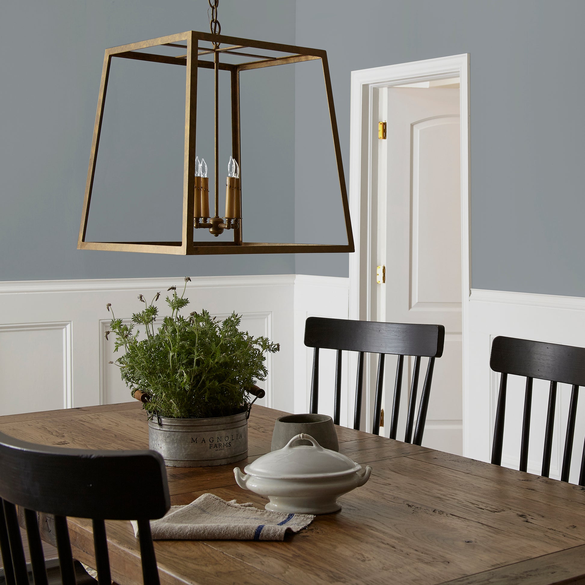 dark grey with blue undertone paint named deep rock shown painted on dining room wall