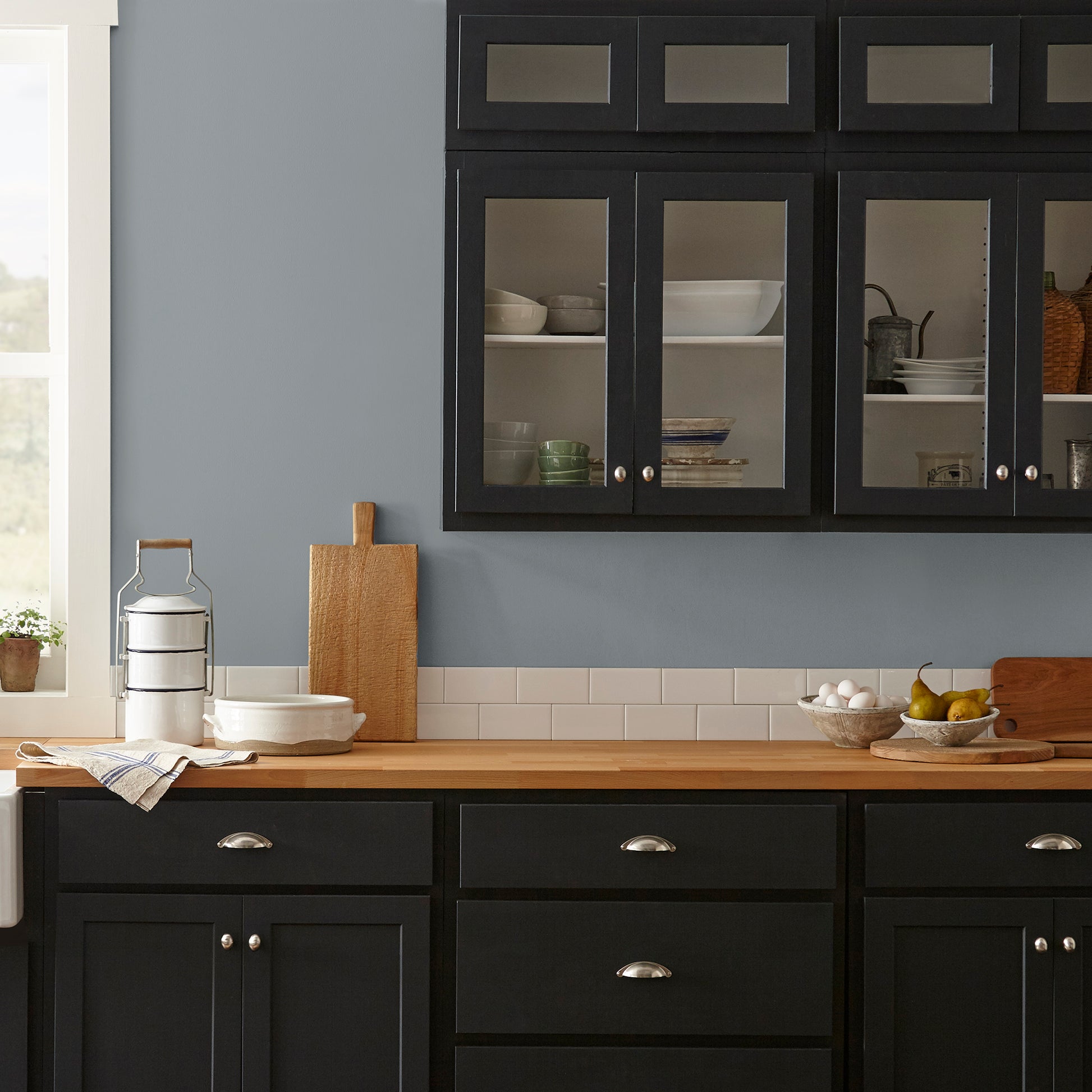 dark grey with blue undertone paint named deep rock shown painted on kitchen wall