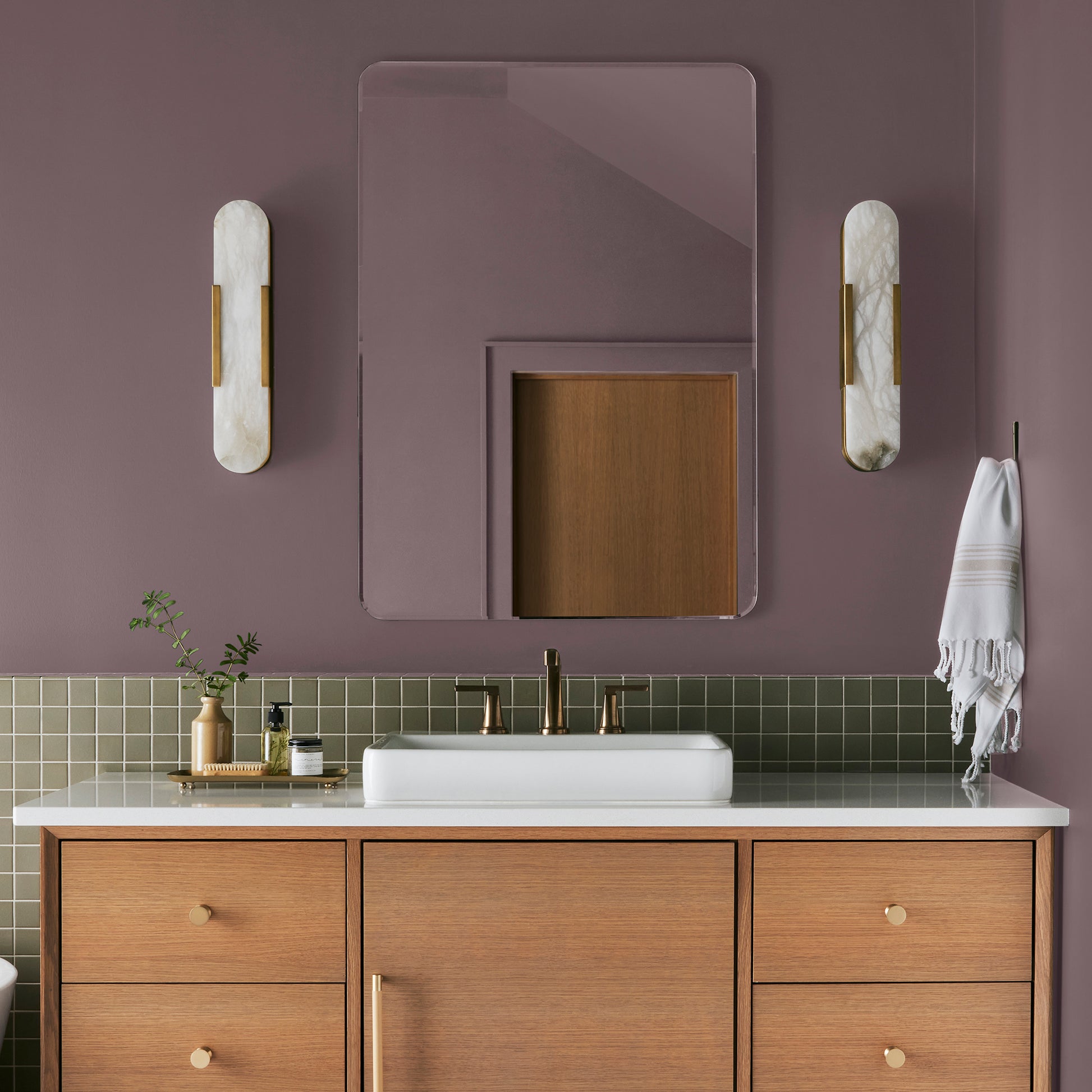 Deep and dusty berry interior paint named webster avenue shown painted on bathroom wall