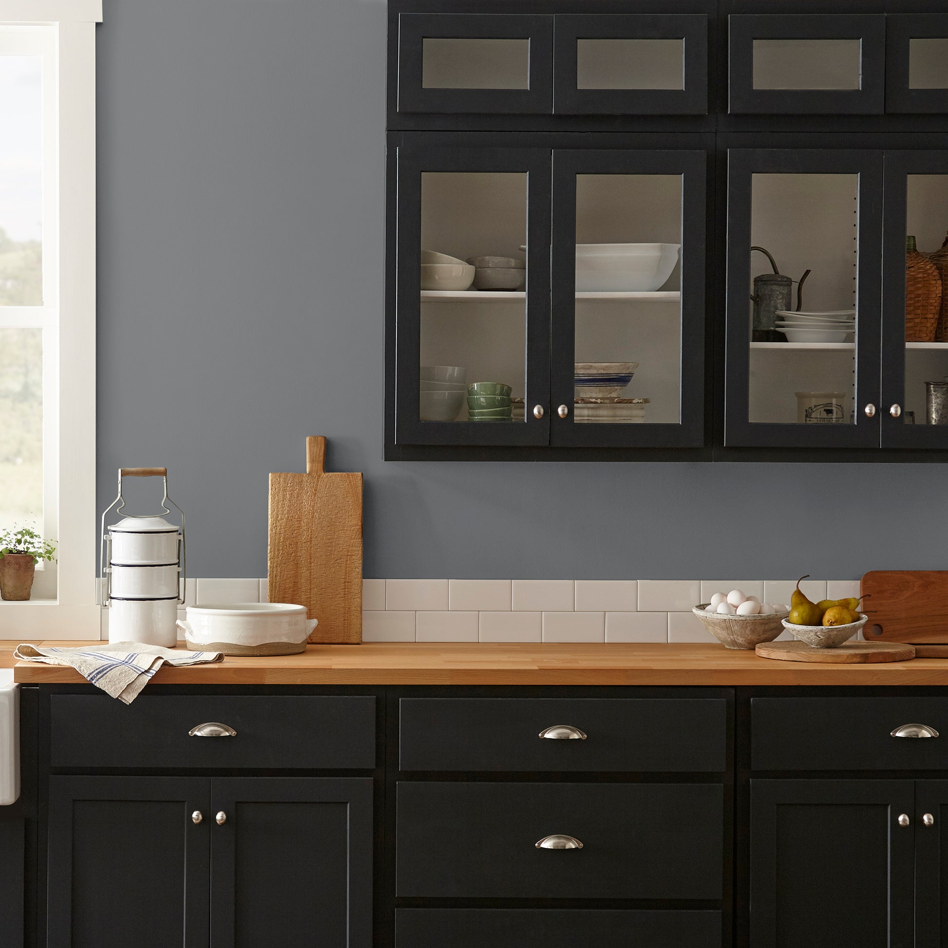 Deep slate gray paint with blue undertones named texas storm shown painted on kitchen wall