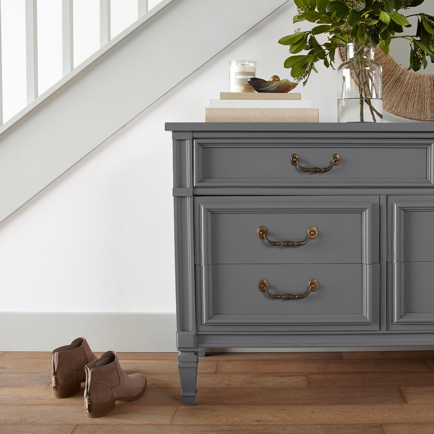 A dark charcoal gray door and cabinet paint named autumn gray shown painted on entryway cabinet