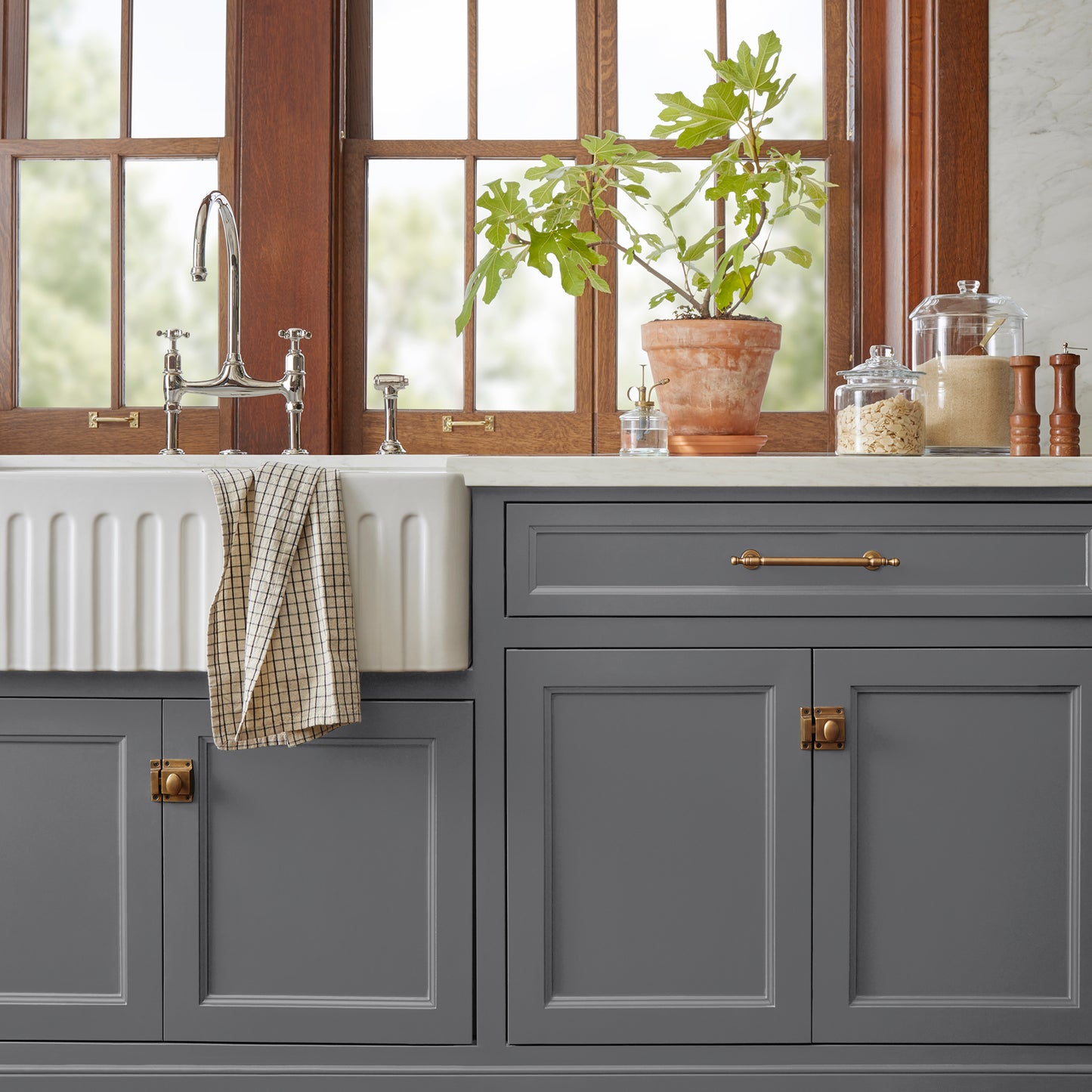A dark charcoal gray door and cabinet paint named autumn gray shown painted on kitchen cabinet