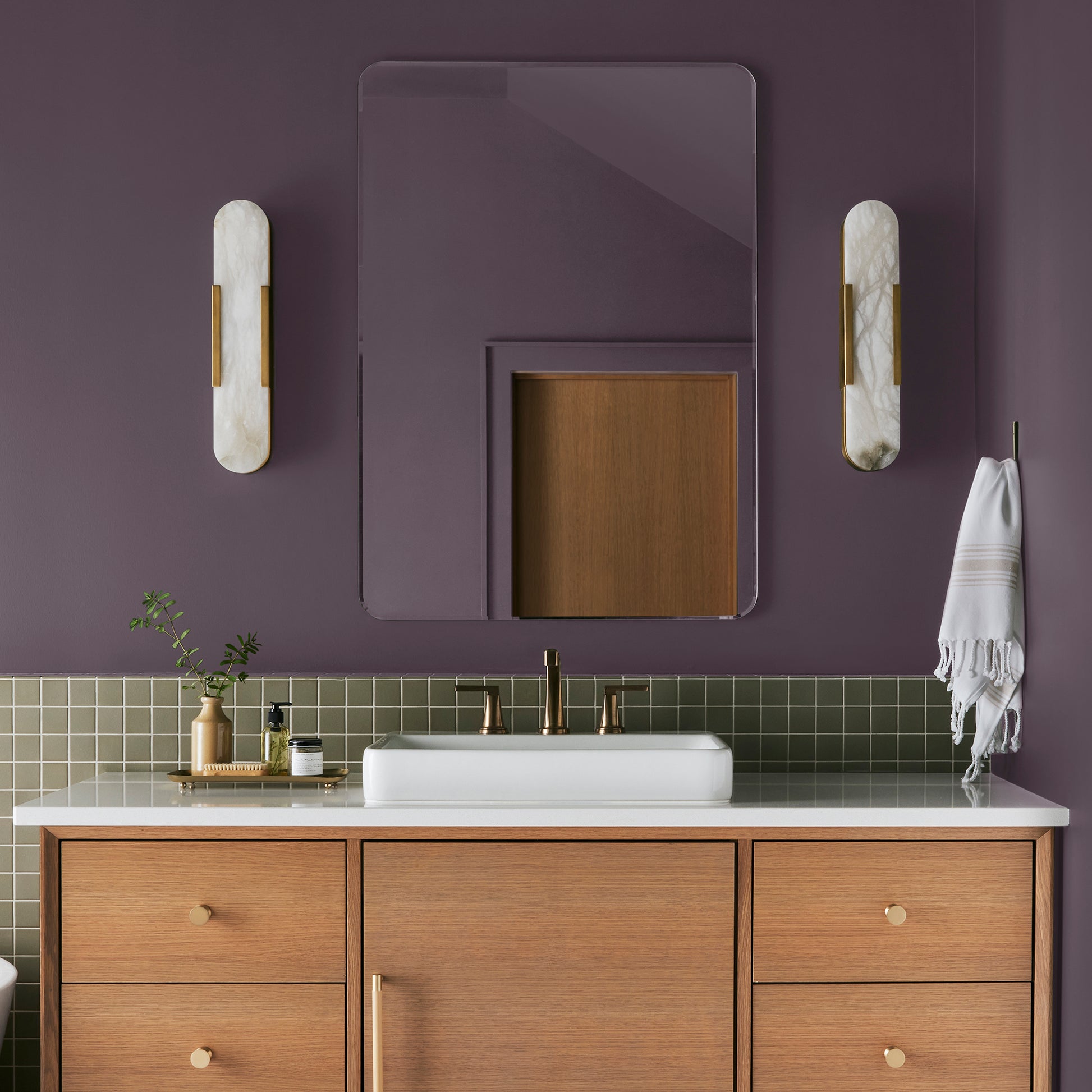 Deep eggplant purple interior paint named plum suede shown painted on bathroom wall