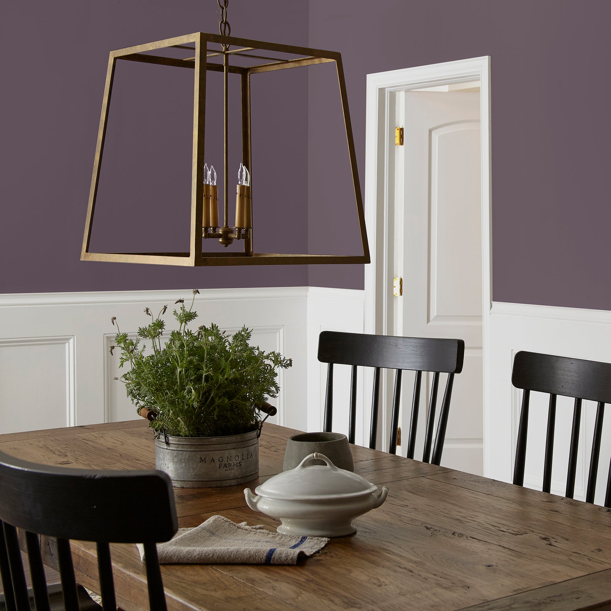 Deep eggplant purple interior paint named plum suede shown painted on dining room wall