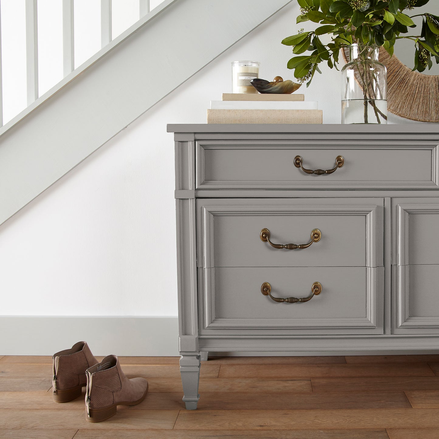 Muted gray with lavender hues door and cabinet paint named watering can shown painted on entryway cabinet