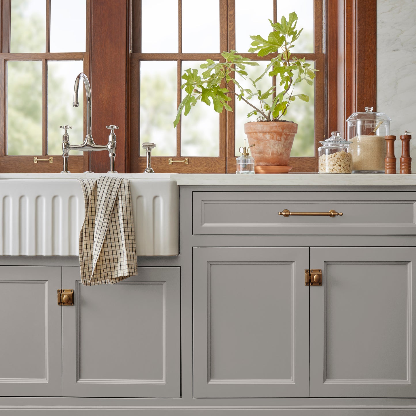 Muted gray with lavender hues door and cabinet paint named watering can shown painted on kitchen cabinet