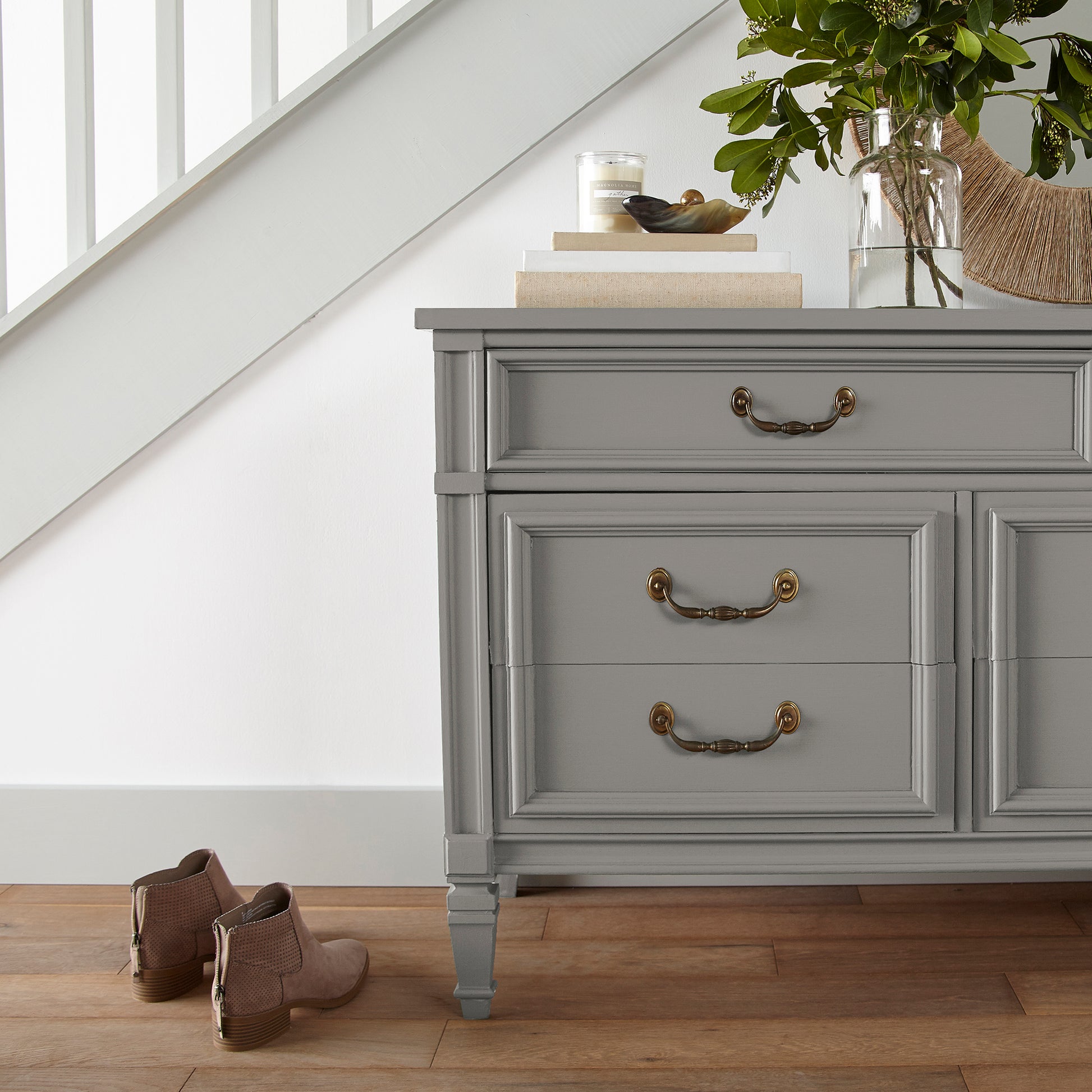 A mousy grayed brown door and cabinet paint named before and after shown painted on entryway cabinet