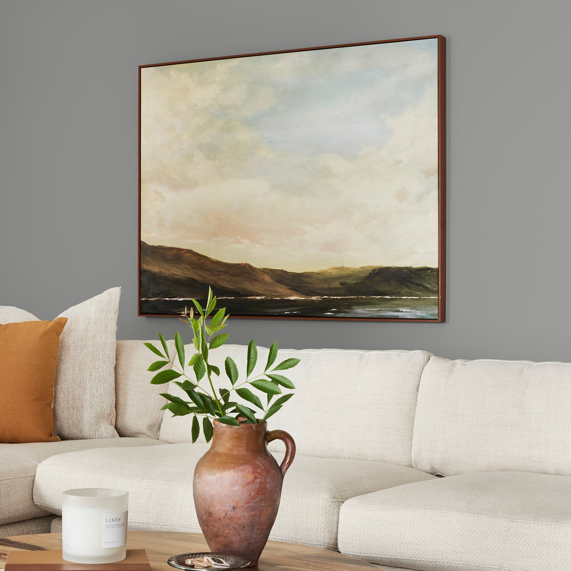 A warm mid-tone gray interior paint named cozy up shown painted on living room wall