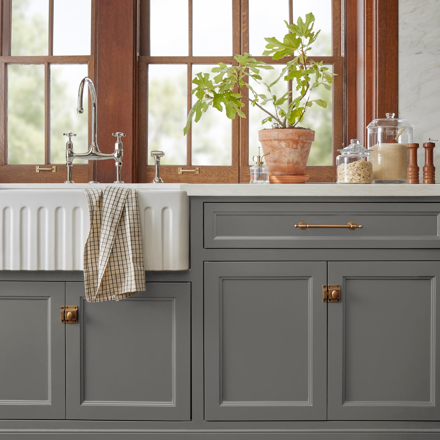 Dark gray touched brown door and cabinet paint named salvaged shown painted on kitchen cabinet