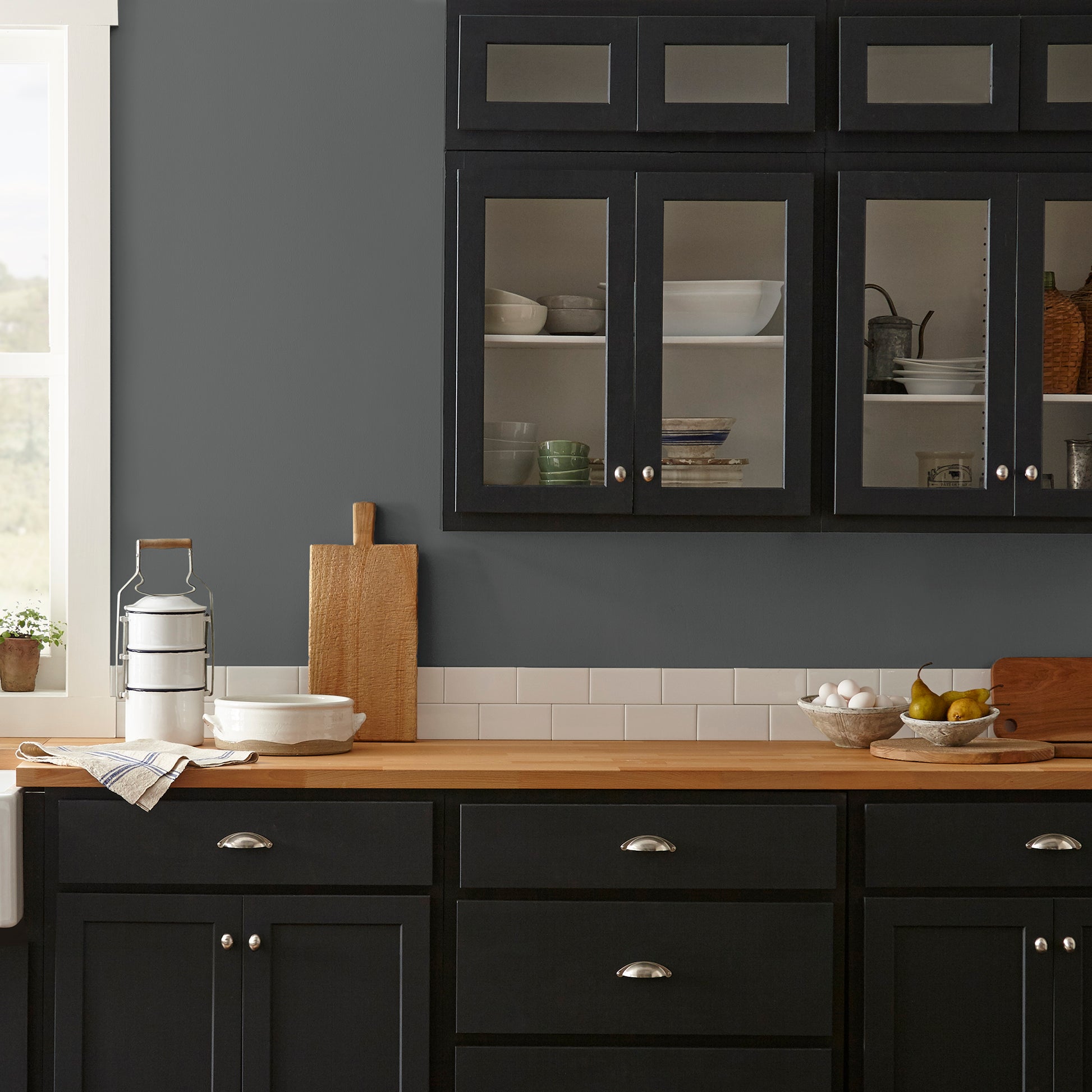 A chalky black interior paint named aspen stone shown painted on kitchen wall