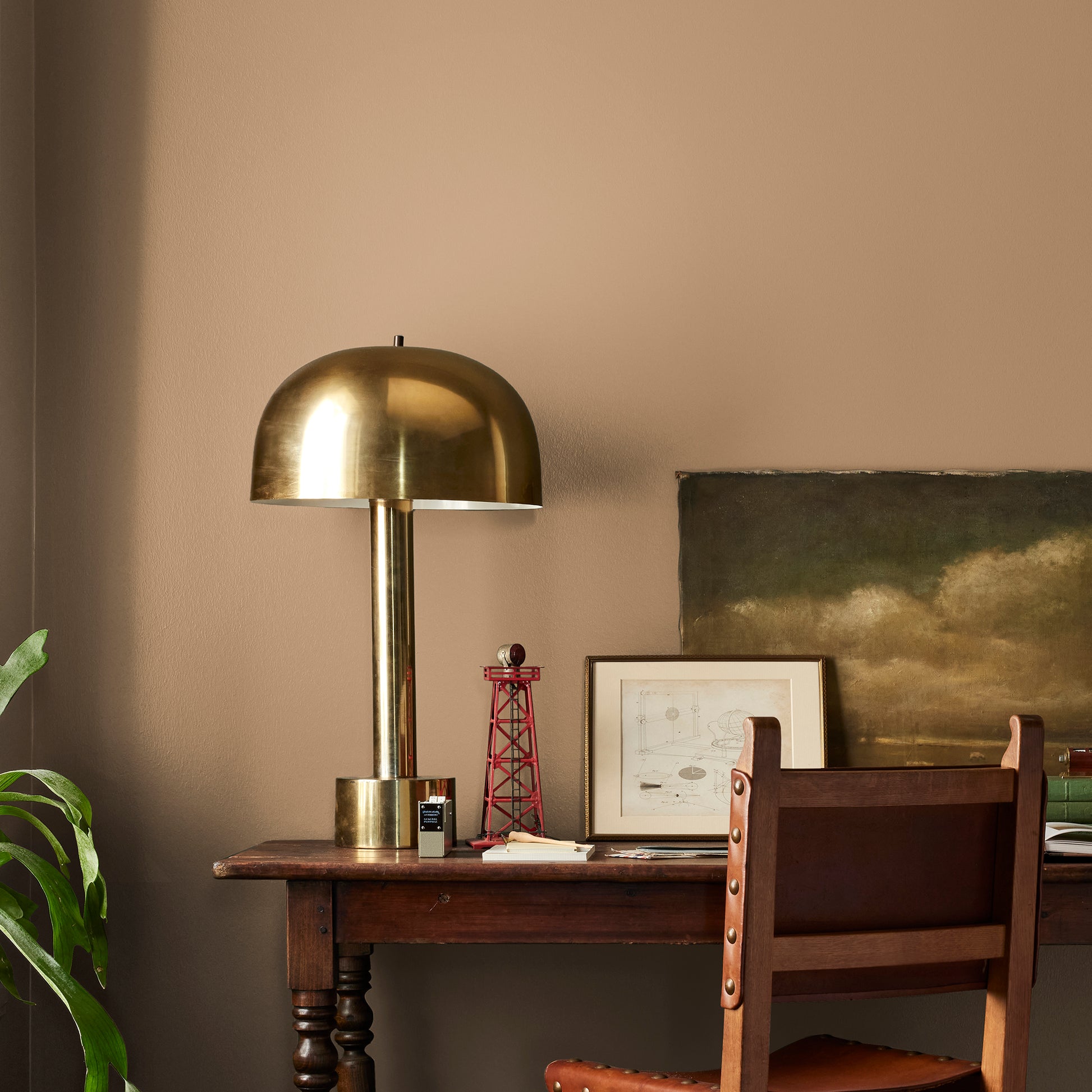 Muted gold interior paint named vintage crown shown painted on bedroom wall
