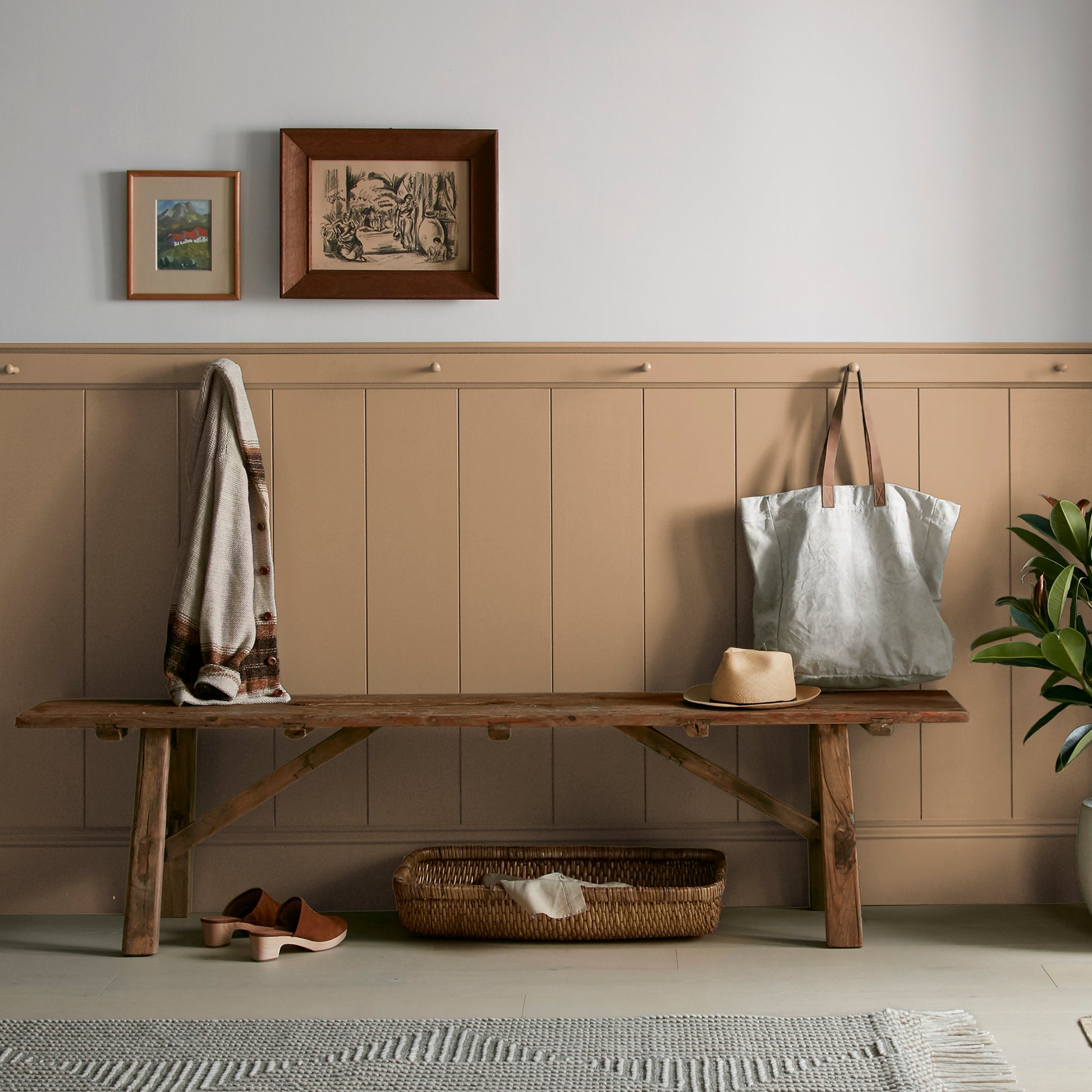 Muted gold interior paint named vintage crown shown painted on entryway wall
