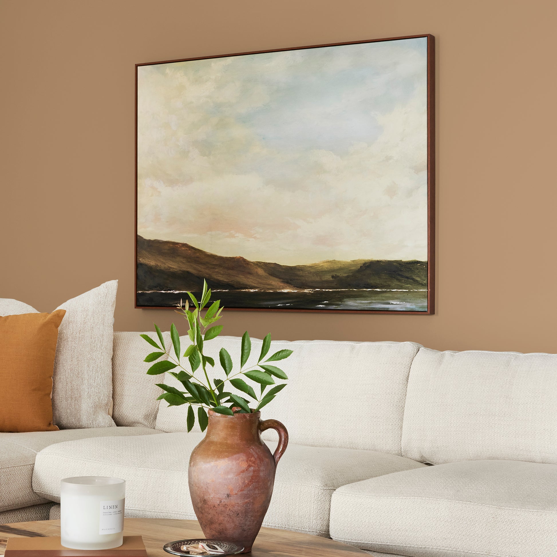 Muted gold interior paint named vintage crown shown painted on living room wall