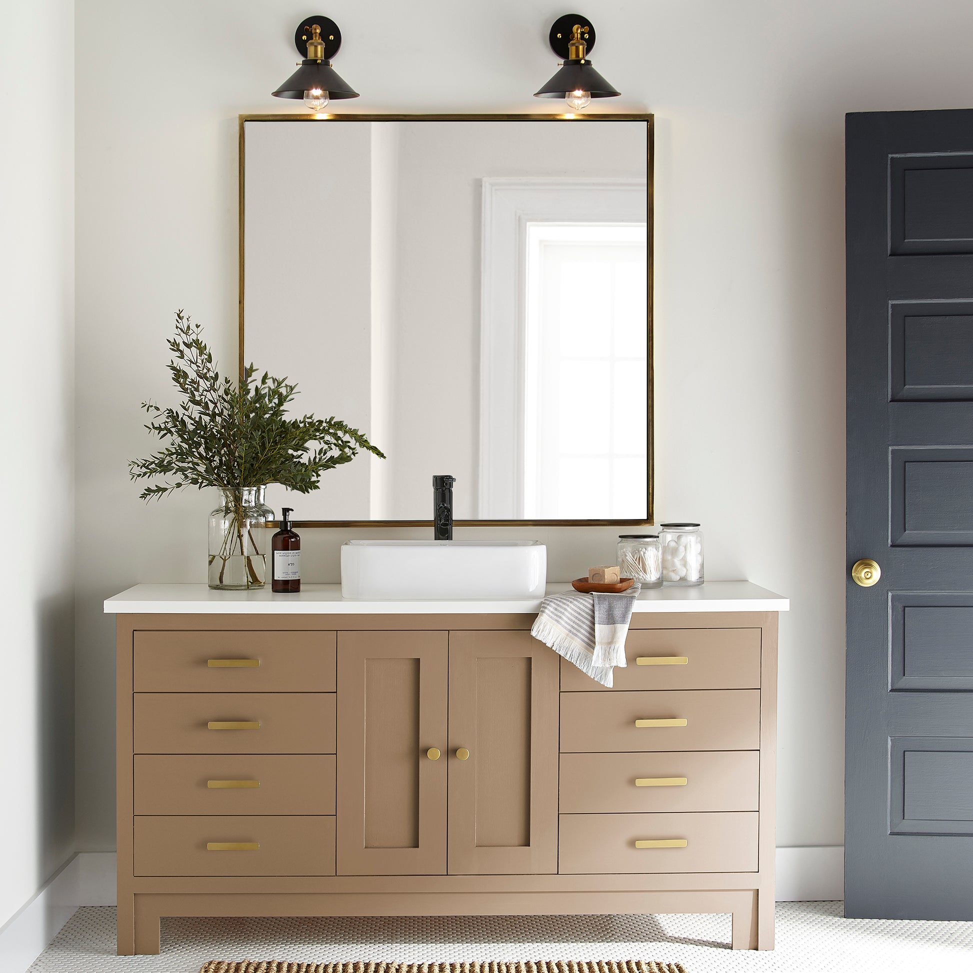 An elegant, muted gold door and cabinet paint named vintage crown shown painted on bathroom cabinet