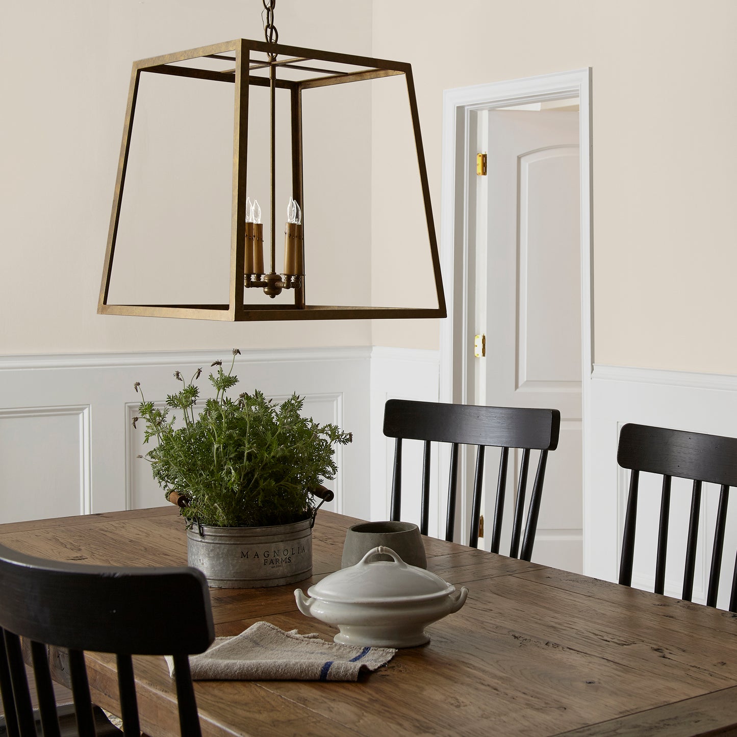 Creamy soft white interior paint named castle cream shown painted on dining room wall