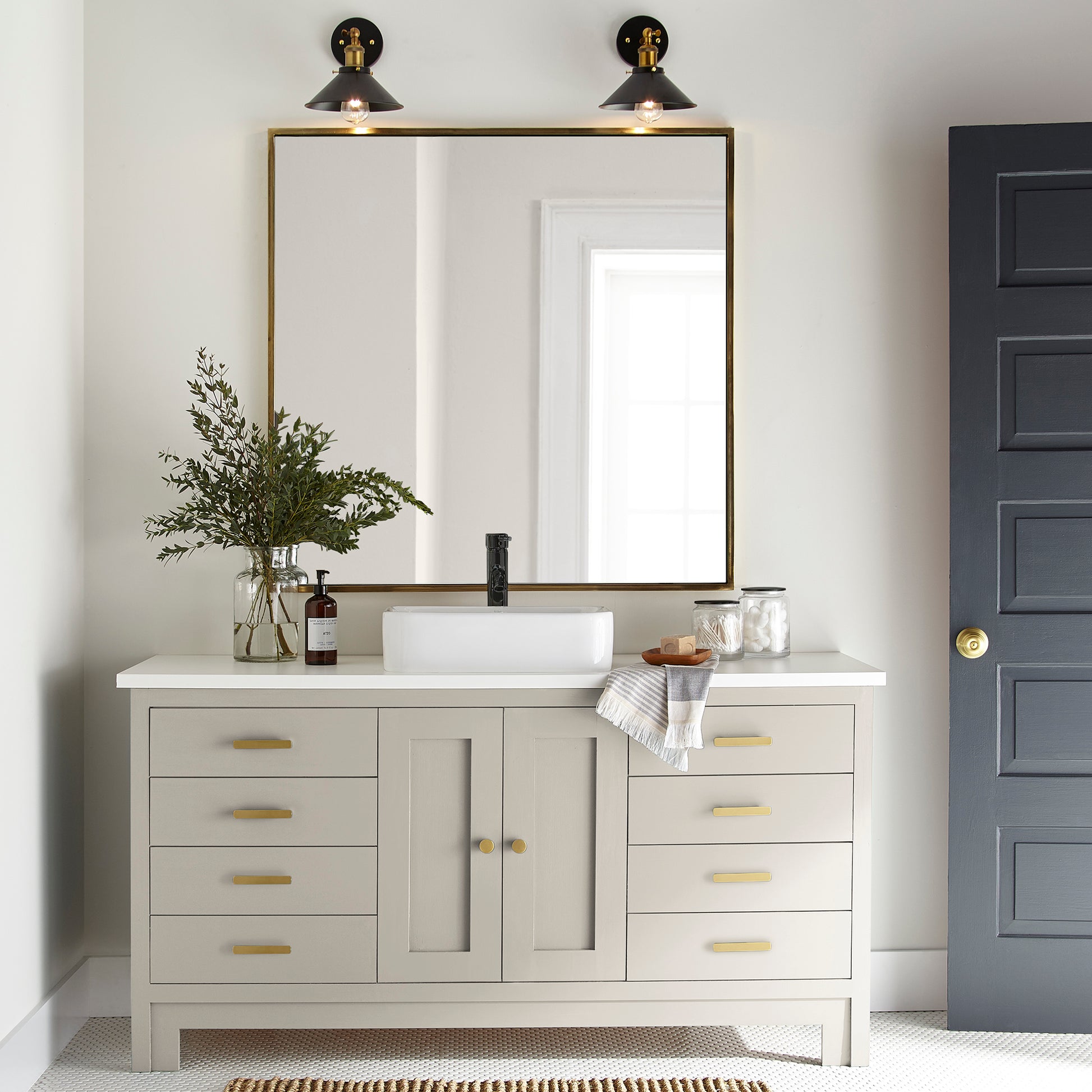 A creamy, soft white with a timeless essence door and cabinet paint named castle cream shown painted on bathroom cabinet