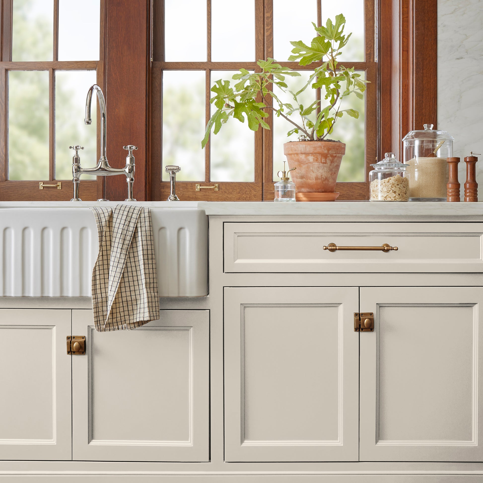 A creamy, soft white with a timeless essence door and cabinet paint named castle cream shown painted on kitchen cabinet