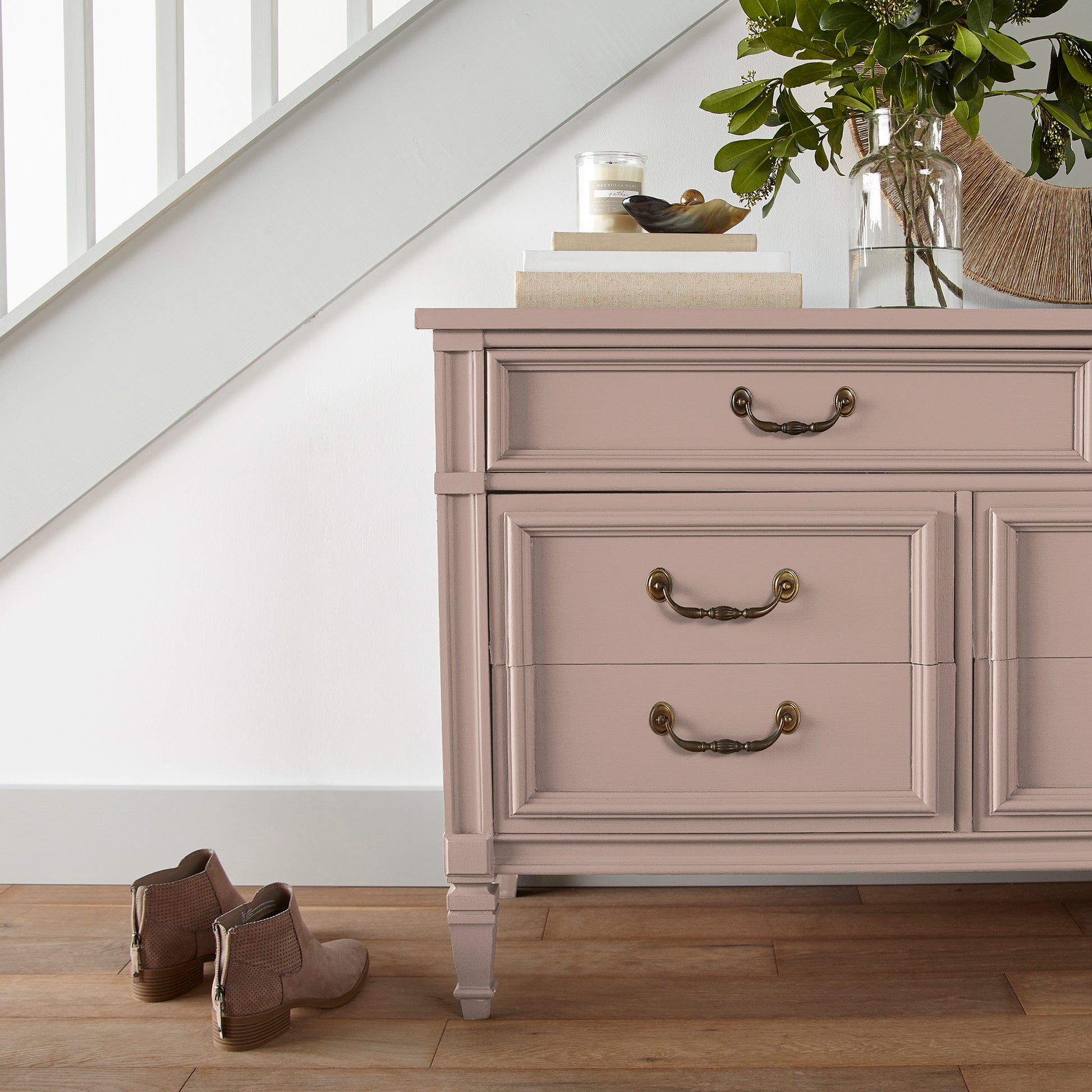 A dusty, subtle pink with a nostalgic tone door and cabinet paint named rosy pink shown painted on entryway cabinet