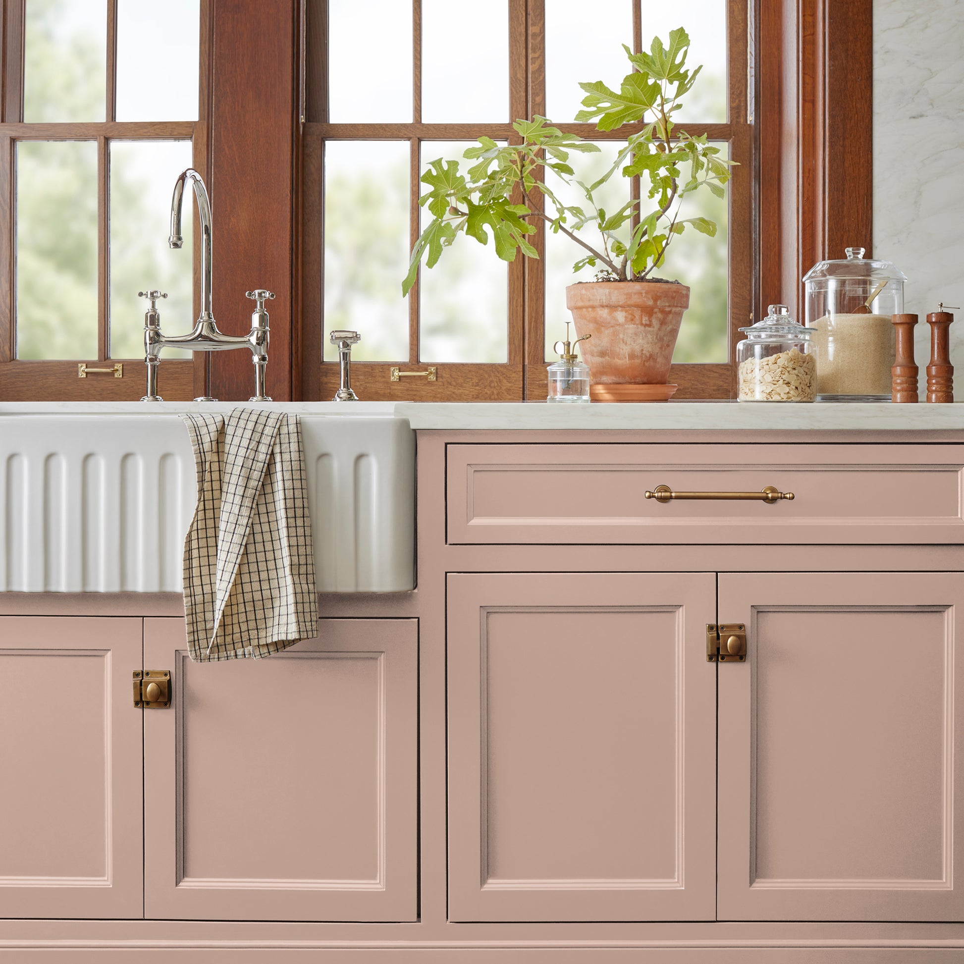 A dusty, subtle pink with a nostalgic tone door and cabinet paint named rosy pink shown painted on kitchen cabinet